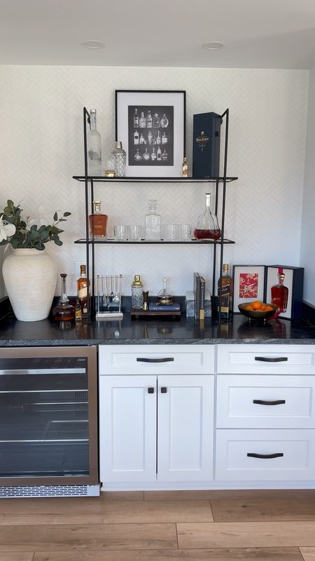 I sure love a before and after!!  By adding this glass shelf it has truly elevated the space! Repurposing leftover herringbone tile from my kids' bathroom was a genius move - it adds such a fun touch!

Bar, kitchenette, home decor 

#LTKstyletip #LTKsalealert #LTKhome