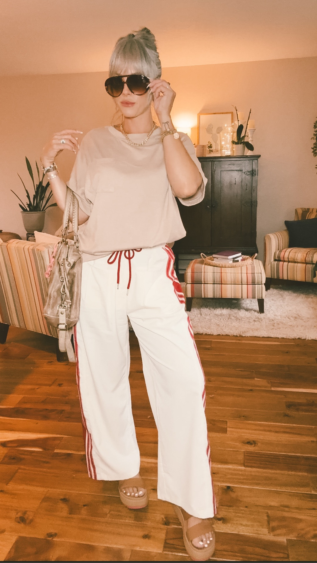 In a medium in the pants and in the top pants run pretty true to size maybe just a tad bit oversize. The T-shirt is a true oversize T-shirt. I can’t link the purse because I got it secondhand.  #momstyle #trackpants #falltransition ￼

#LTKootd #LTKmomlife #LTKOver40