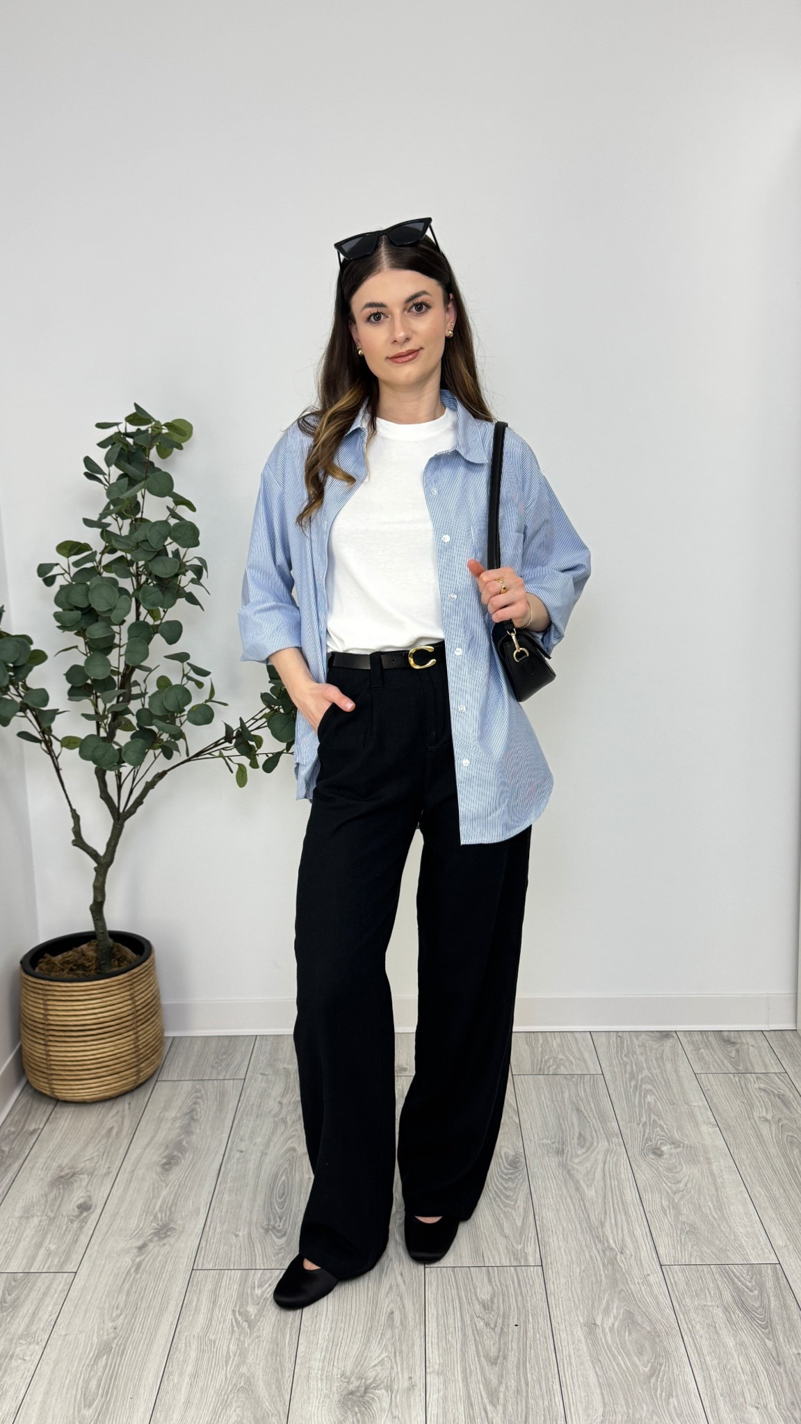 A crisp white tee and black wide-leg trousers, layered with a relaxed blue striped shirt. Finished with black ballerina flats, a sleek belt, and a structured bag—effortless sophistication 🦋 #IlaStylesDiary 

#LTKworkwear #LTKeurope #LTKspring