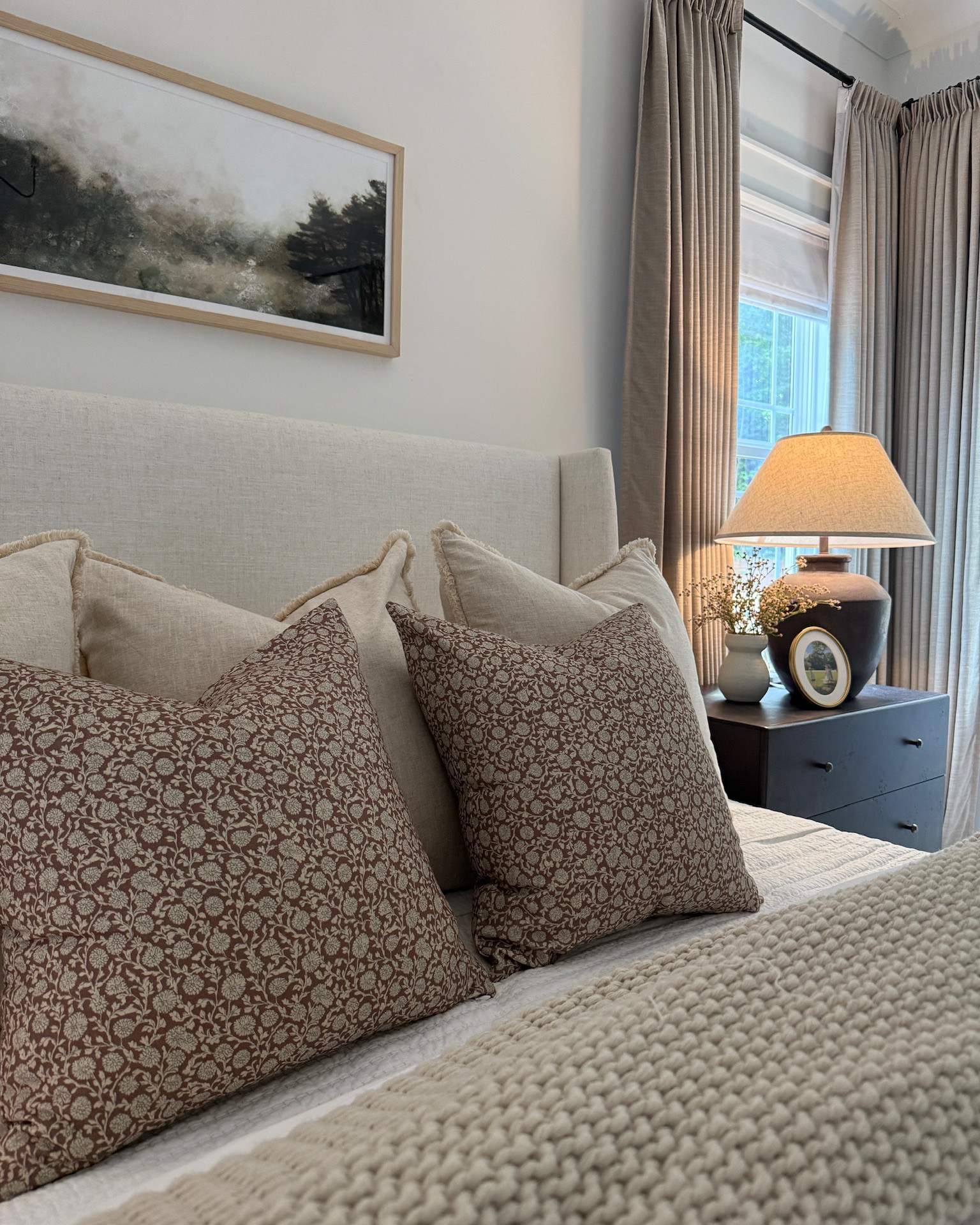 Cozy, layered, neutral bedding look in our primary bedroom! The floral pillows add a charming touch as well🤍