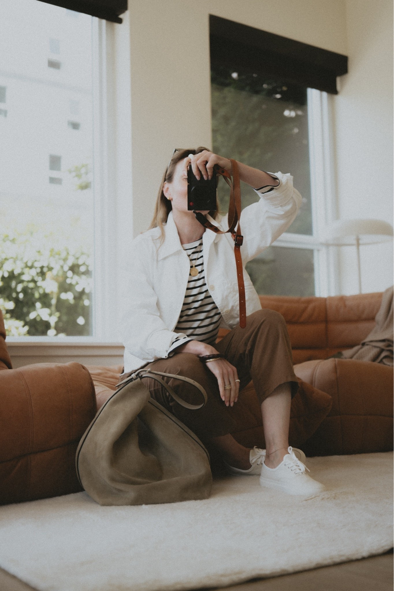 Canvas sneakers + barrel leg pants + white denim jacket + mariniere + hobo bag
Denim jacket: Buck Mason
Pants: Nili Lotan Emerson
Shoes: Common Projects 
Bag: Toteme belted tote 
Top: &other stories, older

#LTKootd #LTKWorkwear #LTKSeasonal