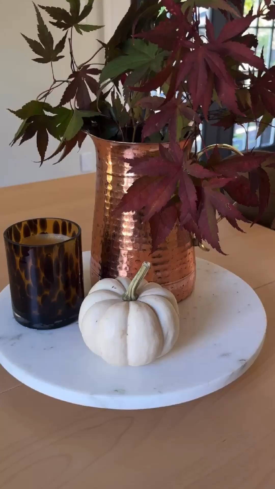 Fall centerpiece 💡 Using a marble lazy Susan, copper pitcher with branches from my yard, tortoise glass candle, and a little pumpkin 🍂

#LTKVideo #LTKSeasonal #LTKStyleTip