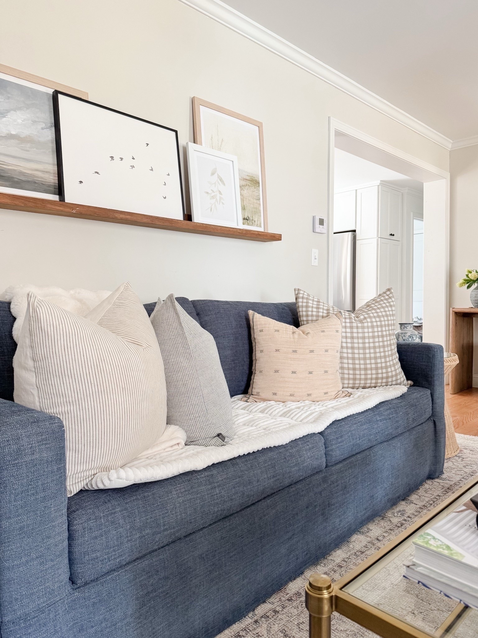 Coastal living room styled with neutral throw pillows, textured ivory rug, faux florals, and layered sofas for a relaxed high end coastal look.

coastal living room decor,  neutral sofa styling, coffee table florals, light coastal interiors, sherricalnanhome 

#LTKHome