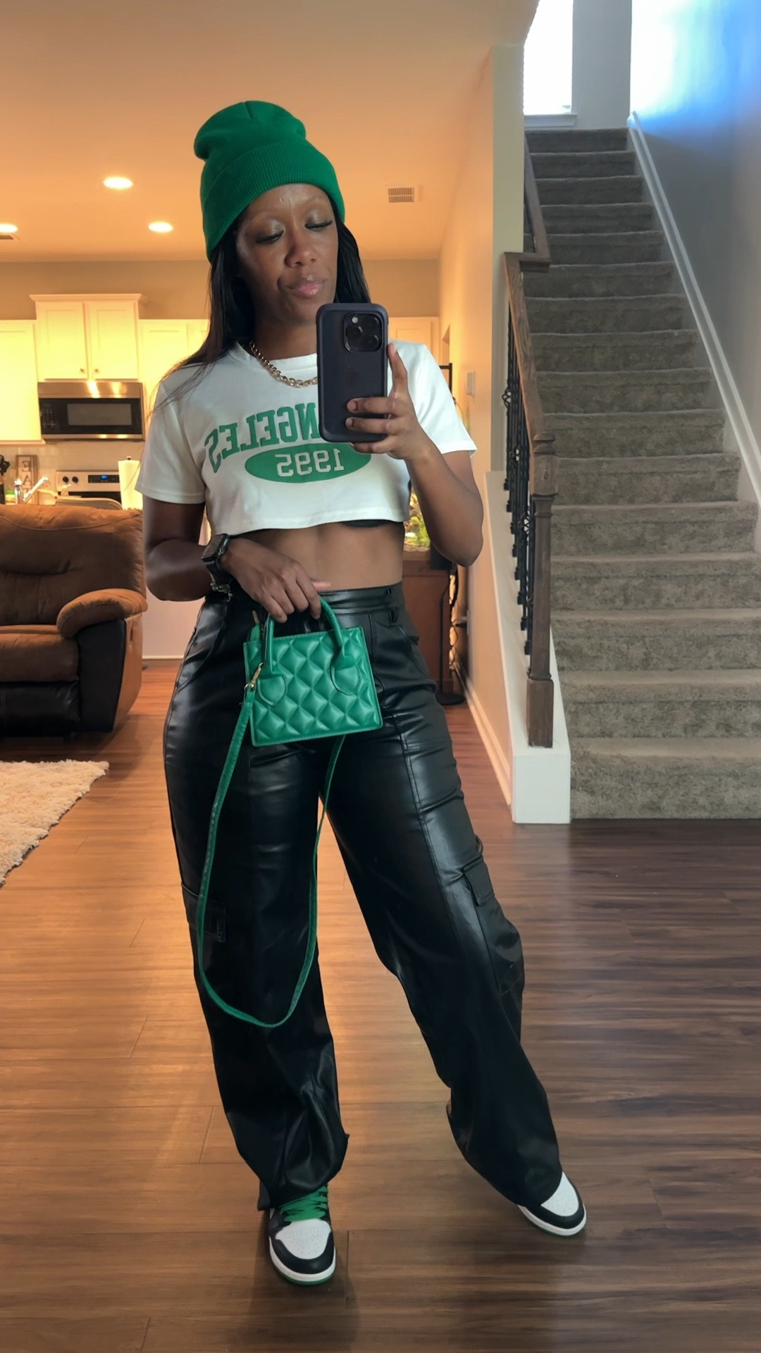 How to style black faux leather pants. I styled these wide leg pants with a cropped graphic tee, green beanie, green purse, and Jordan 1 lucky green sneakers 

#LTKFindsUnder100 #LTKSeasonal #LTKStyleTip