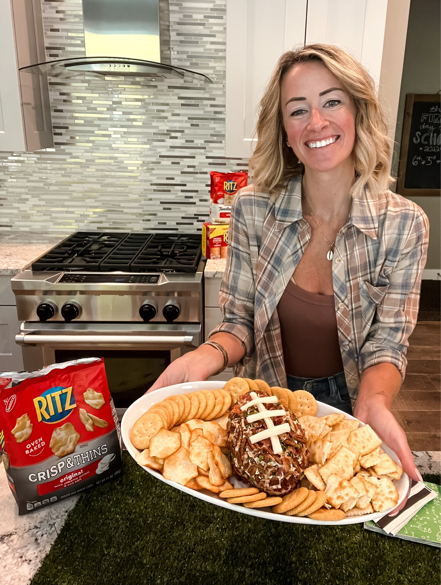 Dave is a huge football fan. Me? I’m a fan of the snacks and fantasy football trash talk 😉 We host a handful of tailgates throughout the fall - mixing up recipes is a must, so I gave our fave Bacon Ranch Cream Cheese Dip a football makeover! 

Ingredients: 
- 5 strips of bacon, crumbled 
- 1/4 cup of chopped pecans
- 1/4 cup of chopped parsley
- 2 8oz packages of cream cheese (softened)
- 1 teaspoon of minced garlic 
- 1 cup of shredded cheddar cheese 
- 1 package of Ranch seasoning 
- 1 teaspoon of Worcestershire sauce
- 1 string cheese 
- Your favorite veggies or crackers for dipping!

Recipe:
1. In a bowl, mix half the pecans, half the bacon, and half the parsley. Set aside! You’ll use this to coat the cheese ball!
2. Using an electric mixer (paddle recommended!), beat the remaining ingredients on medium until it’s well-combined.
3. Scoop into plastic wrap, and form into a football shape (keeps your hands clean-er).
4. Chill in the fridge for an hour.
5. Remove from plastic and roll in the bacon, parsley, pecan mixture to coat. 
6. Top with pieces of string cheese to make football laces.
7. Serve with your favorite crackers or veggies! 

Will you try this for your next football watch party?