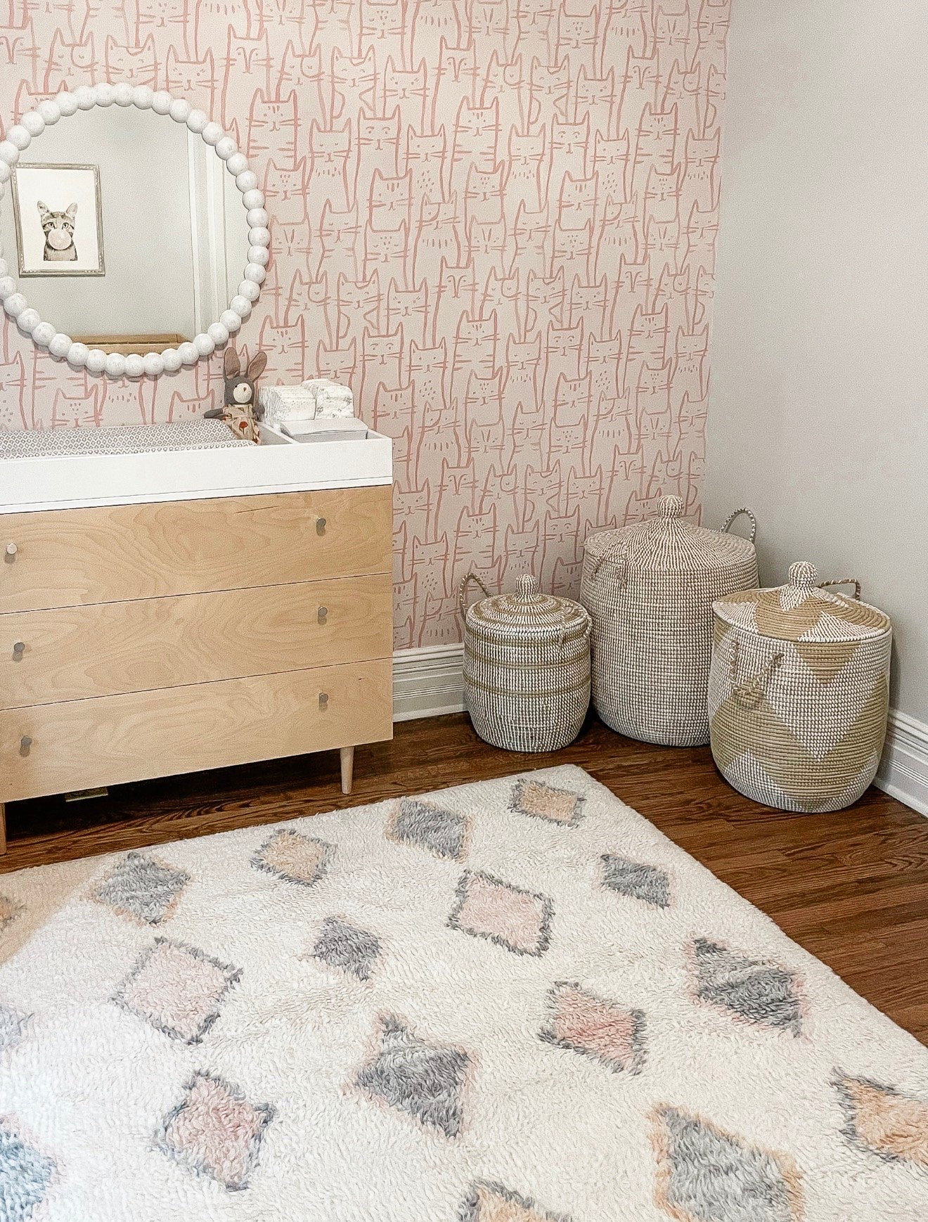 The wallpaper may be the boldest pattern in the room, but the rug and woven baskets keep the mix feeling layered instead of overwhelming. Sticking with soft pinks, grays and neutrals helps everything work together.

cat wallpaper, nursery decor, patterned rug, woven baskets, pink nursery, pattern mixing, kids room decor, wallpaper inspiration, layered decor, Girl on the Hudson

#LTKHome #LTKBaby