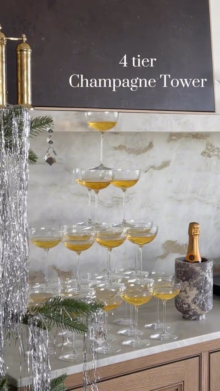 Or sparkling Apple cider 😉

I adjusted my champagne tower a bit to fit in front of the buffet shelf but they are super easy to set up and a quick addition to elevate your party!

For a 4 tier tower you’ll need:
30 champagne glasses
(stack in a rows, adjust sideways for a 💎 shape)
bottom layer: 16
second layer: 9
third layer: 4
top layer: 1