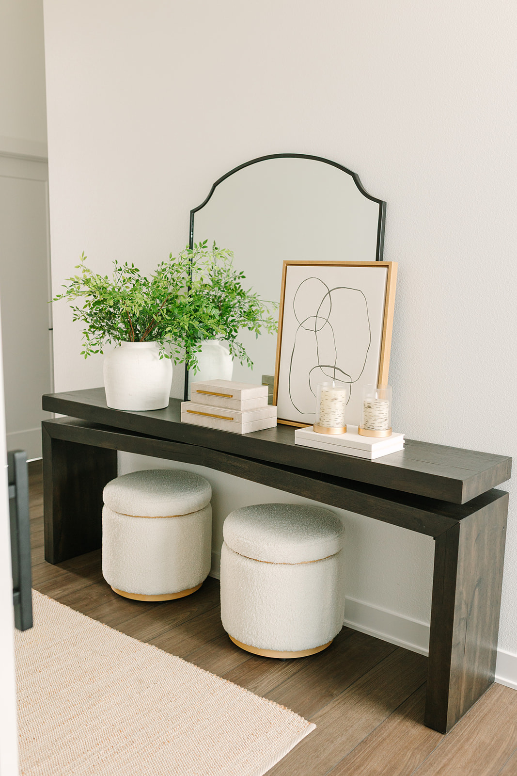 My entryway 🤍 Art, stems, books, ottomans, and gold hurricane votives are all on sale right now and come together to create a warm, welcoming space the moment you walk in. 

 

#LTKHome #LTKSaleAlert
