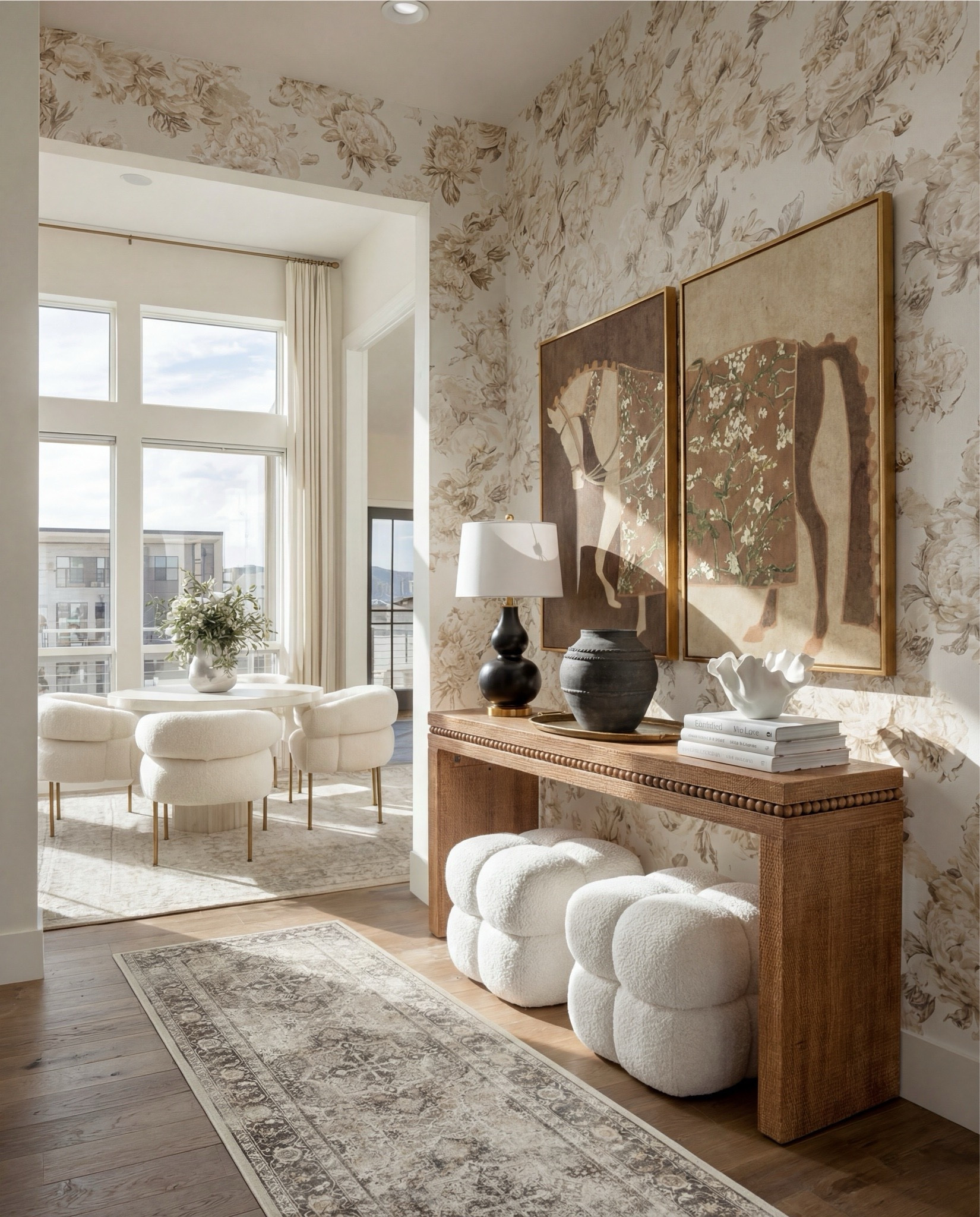 Shop the Look:
• Neutral floral wallpaper (beige + taupe tones)
• Solid wood console table (warm oak finish)
• Beaded edge console table detail
• Framed vintage-style art prints (earthy brown tones)
• Brass picture frames
• Black ceramic table lamp with white shade
• Decorative table tray (antique brass)
• Stone or ceramic vase (charcoal gray)
• Sculptural white bowl (organic shape)
• Coffee table books (neutral covers)
• Bouclé cube ottomans (ivory)
• Light wood flooring
• Vintage-style area rug (muted beige + gray)

#LTKSaleAlert #LTKHome