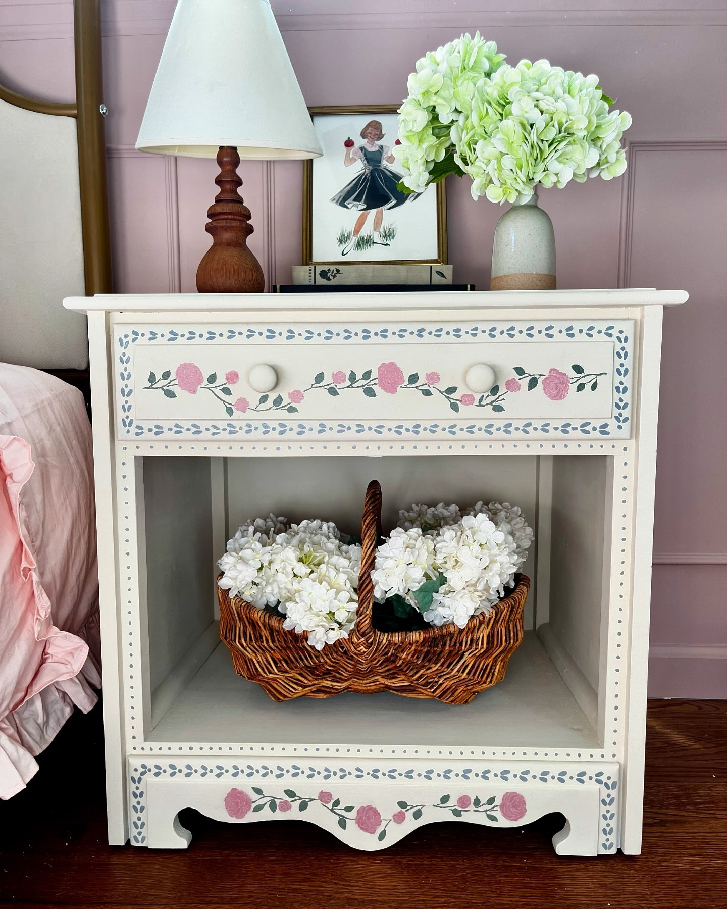 #sundaystills of this sweet space for the sweetest girl 🥰

This week I worked on hand-painting this old nightstand that used to be in my room. I used the color Drop Cloth from @dixiebellepaint and their silkscreen rose stencil to create the flowers. I wanted a rustic look, so for once I didn’t try to make it perfect. 

The other handmade pieces that I love here are the lamp and painting. My dad made this lamp, and it was the first gift he gave to my mom. The apple girl was drawn by my grandma, when she was a catalog illustrator.

#diyfurniture #diyfurnituremakeover #diyfurnitureflip #diyfurniturepainting