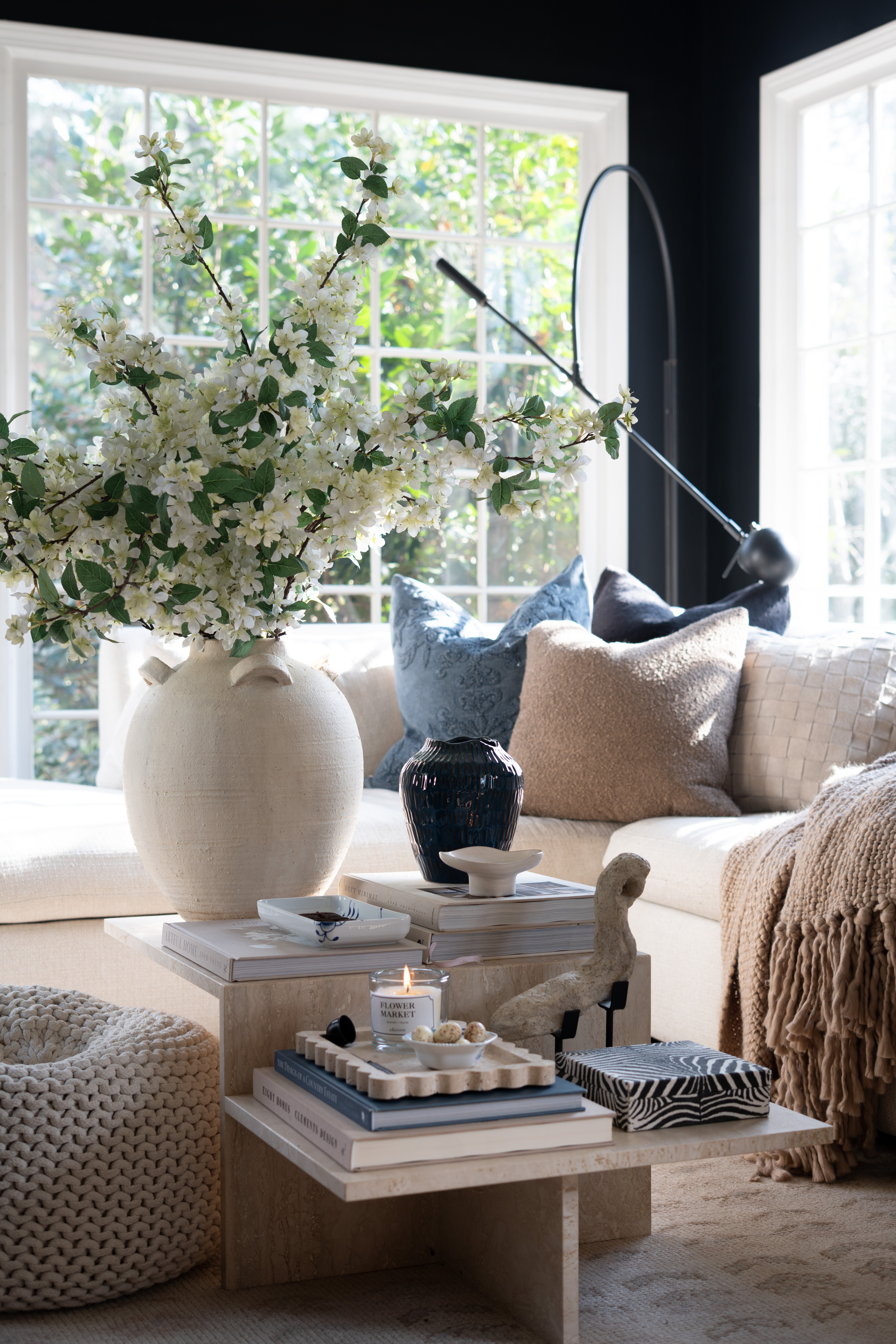 OMG you guys I cannot even handle how dreamy this space feels. The natural light pouring through these big windows, the oversized ceramic vase filled with spring blossoms, and the soft neutral palette are giving the coziest elevated living room vibes. I’m obsessed with the layered coffee table styling, stacked design books, warm textures, and subtle blue accent pillows. This is officially my favorite cozy corner for coffee, a good book, and soaking up all the spring sunshine. Neutral living room decor, marble coffee table styling, and fresh floral arrangements all in one perfect moment. 

 #LTKSpringSale #LTKSeasonal #LTKHome