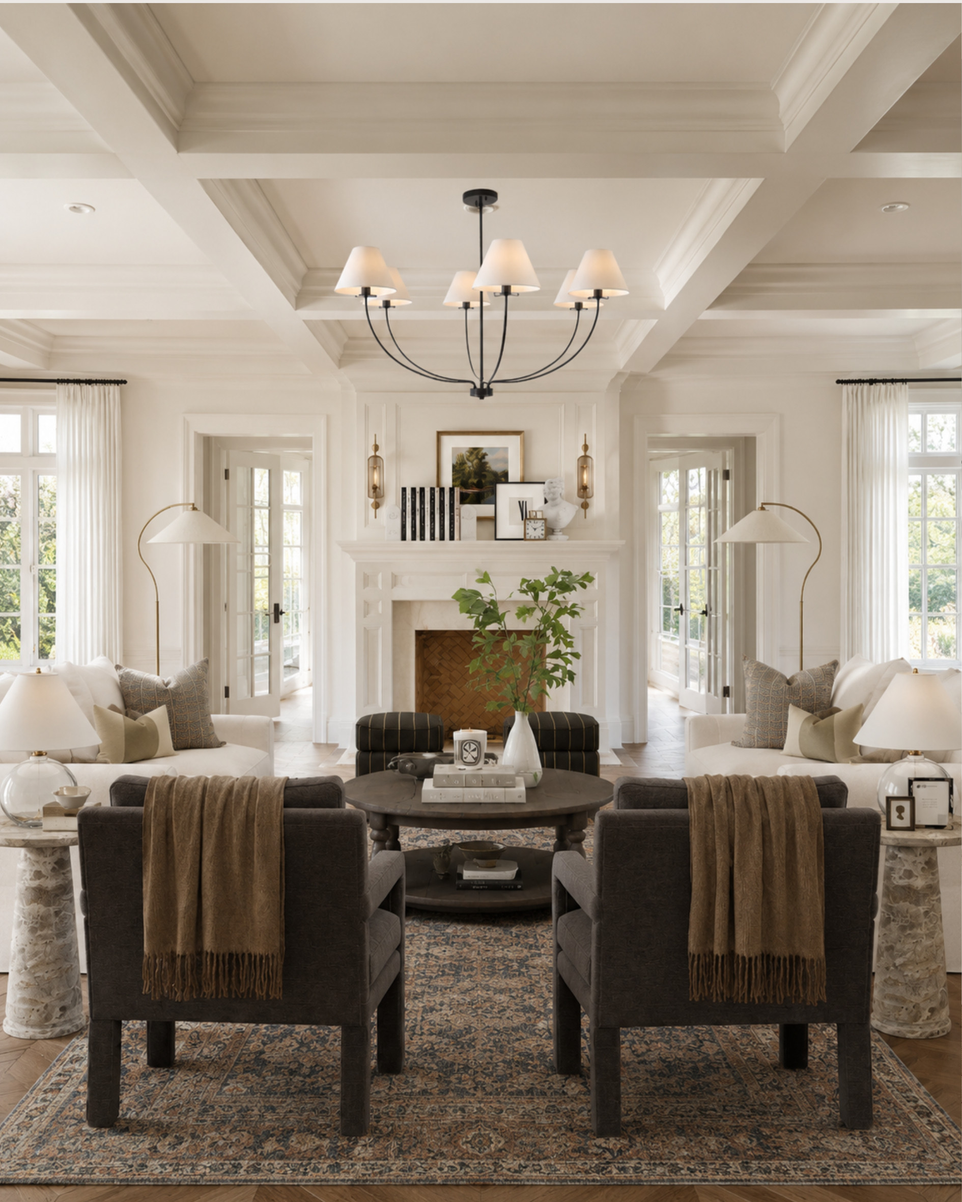 This is your reminder that a neutral living room doesn’t have to feel plain.

The reason this room works is the layering: creamy upholstery, darker accent chairs for contrast, warm throws, sculptural lamps, marble side tables, a patterned rug, and a classic chandelier that pulls the whole space together.

When you’re decorating a neutral room, the trick is to mix tones and textures instead of buying everything in the same shade. Add one or two darker pieces to ground the space, then bring in softer textiles and warm metal finishes so it still feels inviting.

Linked the pieces to help get this layered, classic living room look — especially the lamps, accent chairs, tables, rug, and cozy throws.

This post contains affiliate links and I may earn a small commission from purchases at no additional cost to you. 

 #LTKHome