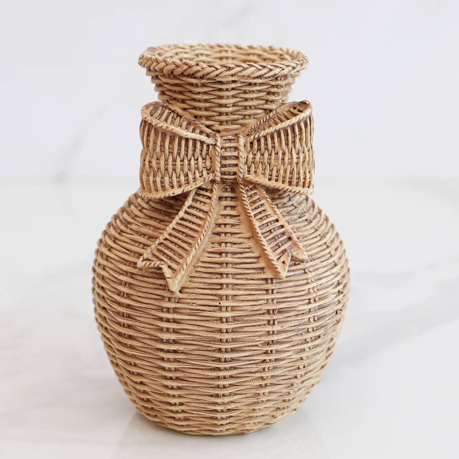 Add a sweet, textural touch to your styling with this Resin Woven Vase featuring a charming bow detail

#LTKHome