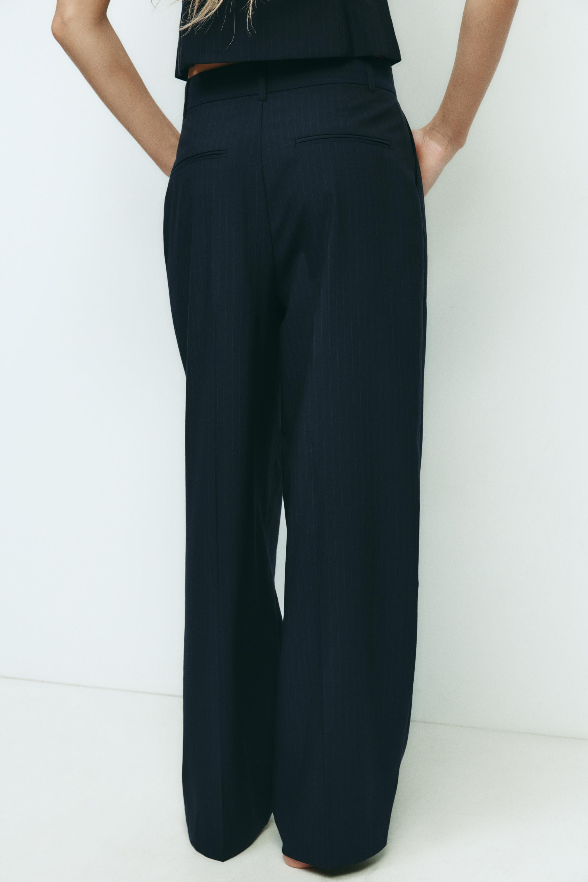 High-waisted pants with belt loops. Pleat detail. Side pockets and back false welt pockets. Front... | Zara US