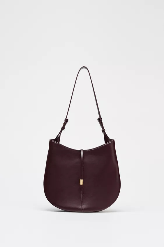 Bucket shoulder bag. Hanger detail with metal piece on the front. Adjustable shoulder strap. Magn... | Zara UK