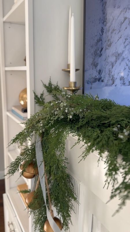 Small mantle styling! I used 2 of the studio McGee garlands + three faux berry fillers. Layer some bells and ribbons, then add height with candle holders! 

#LTKhome #LTKSeasonal #LTKHoliday