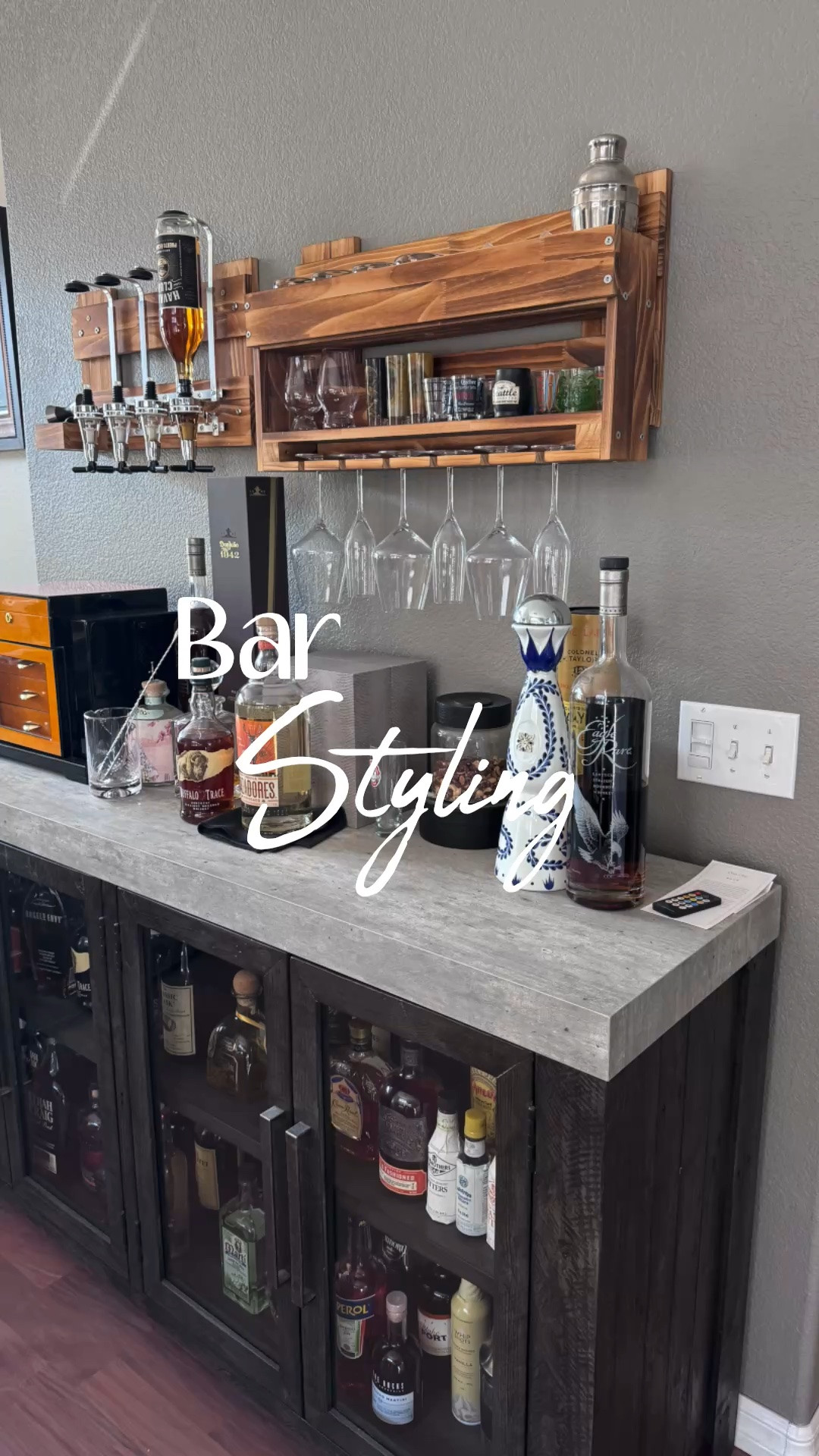 This one is for the gentlemen 🥃 These wood bar shelves are a stylish way to store wine glasses while displaying and dispensing your favorite spirits. If you're a cigar enthusiast, this compact humidor is the perfect place to keep your favorite cigars fresh and organized. One of my favorite additions was installing LED light strips inside the cabinet, which beautifully illuminate the liquor bottles through the glass doors and give the entire space a custom, high-end look. Functional, sophisticated, and perfect for creating a dedicated entertaining space at home.

#LTKHome