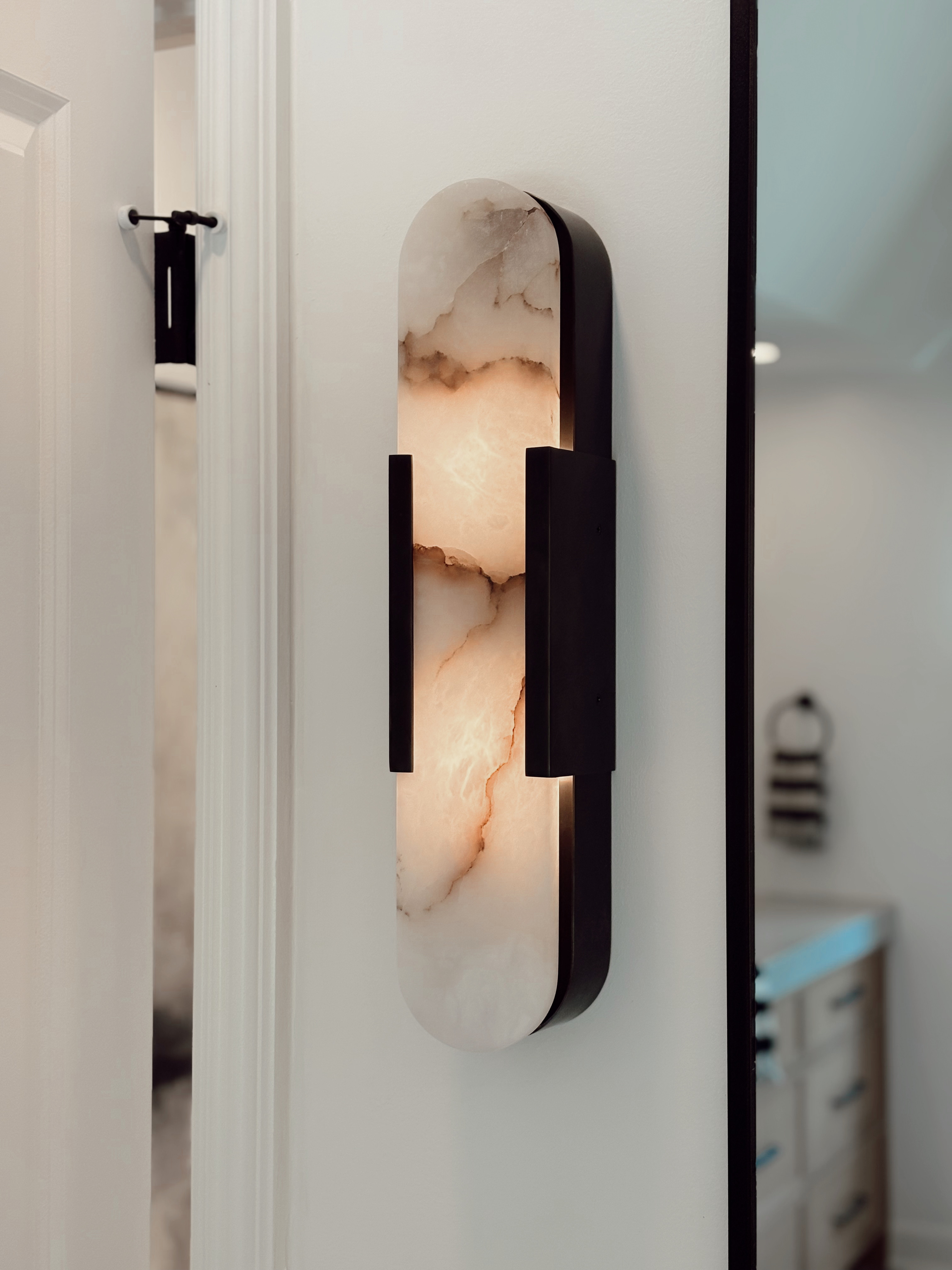 This wall sconce was absolutely made for this home! Wall sconce, bathroom wall decor, bathroom lighting, lighting ideas, wall light, marble light, modern wall light 

 #LTKHome #LTKStyleTip #LTKFamily