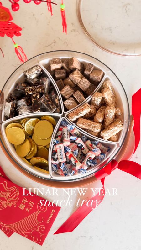 Lunar New Year Snack Tray! 
Divided serving tray with lid and handle, milk chocolate coins, Loacker Chocolate wafers, almond roca, white rabbit creamy candy, artificial plants, hanging pendants, brass vase

#LTKMostLoved #LTKhome #LTKVideo