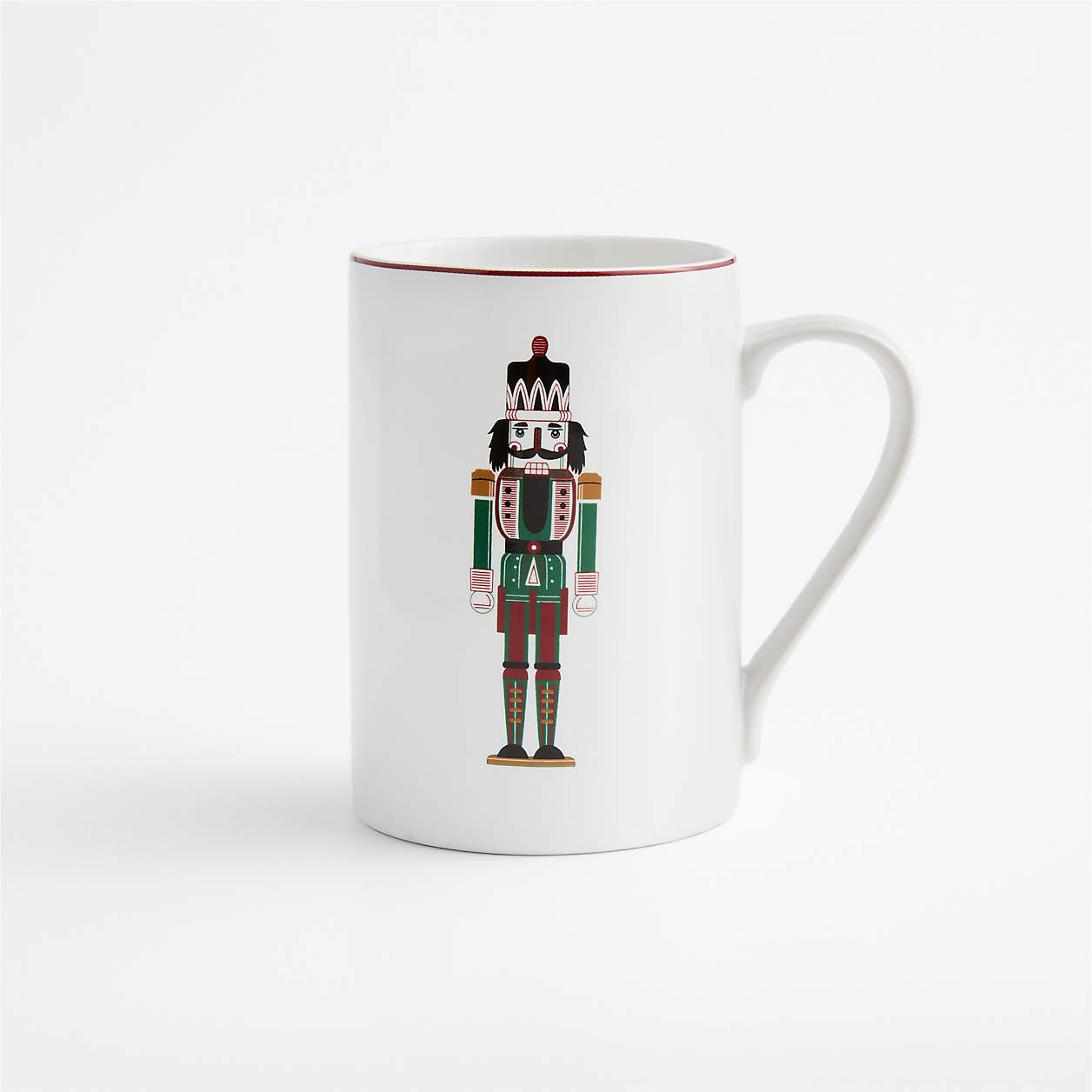 Aspen Red Rim Nutcracker 12.75-oz. Porcelain Can Mug | Crate & Barrel | Crate & Barrel