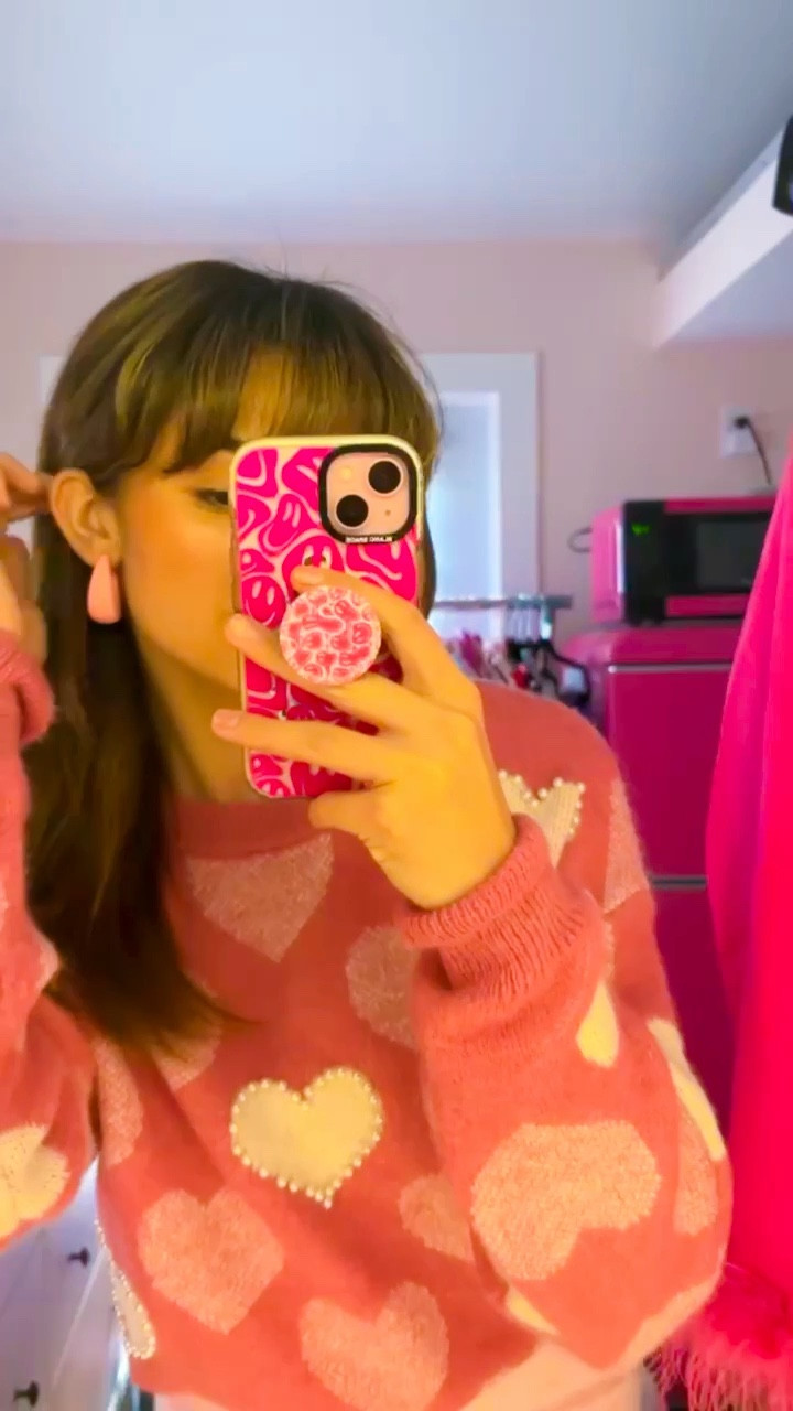 Valentine’s Day outfits: Girls day out edit. Let’s get creative and pair a cute slip dress with a comfy sweater. Galentine’s Brunch is going to be fabulous this year. 
Pink hearts and pearls on this adorable sweater tie in perfectly with the pink skirt and earrings  

Perfect for Brunch date, a day with girls, or your next shopping trip. Grabbing my new blush bow purse. Pssst…. Bows are in this year. You will see them everywhere.