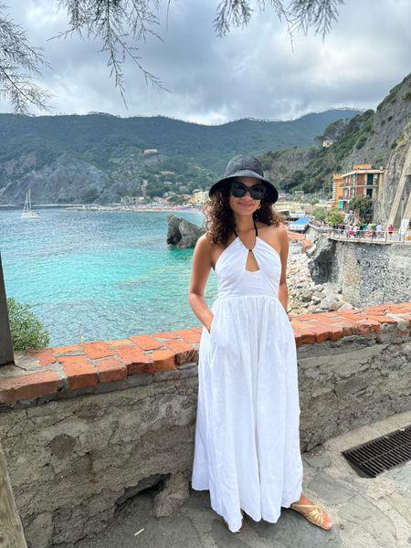 A chic and flirty black and white linen dress for Cinque Terre! (Or for any summer vacation outfit) Paired with gold sandals and a black straw hat 

#LTKTravel #LTKSeasonal