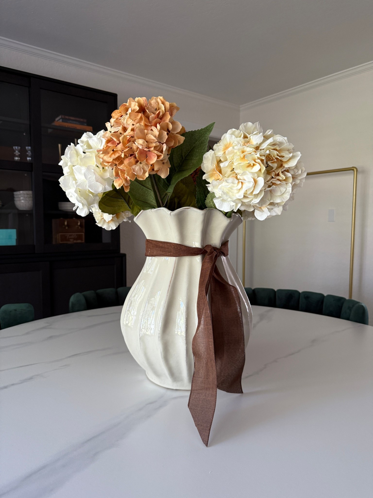 I used eight hydrangeas to fill this vase. It could probably use two or three more. 

#vase #target #hydrangeas #ribbon #holidaydecor 

#LTKSeasonal #LTKHome #LTKFindsUnder50