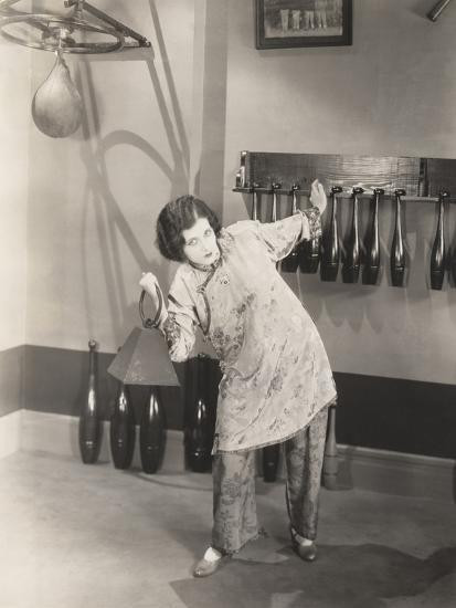 Determined Woman in Silk Pajamas Lifting Weights in Gym Photo Print | Art.com