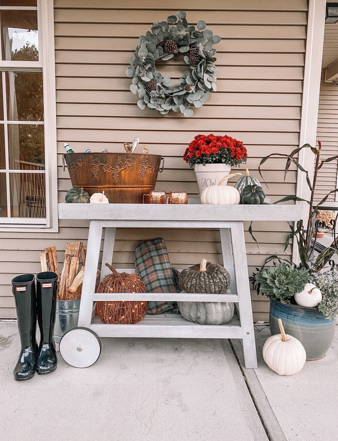 Fall home decor- bar cart turned flower cart and hunter rain boots 