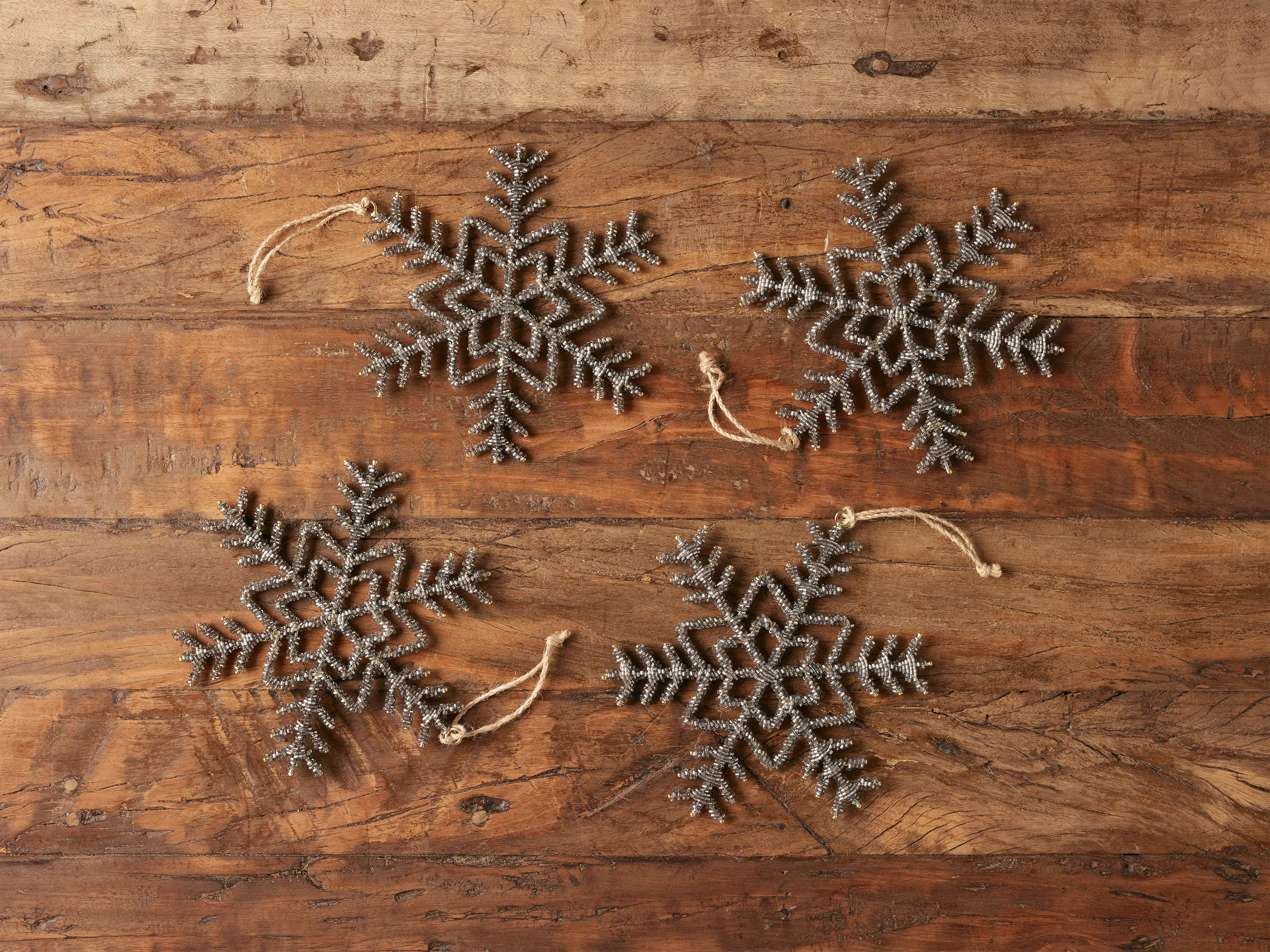 Traditional snowflake silhouettes are refreshed with our sparkling beaded ornaments, accenting an... | Arhaus