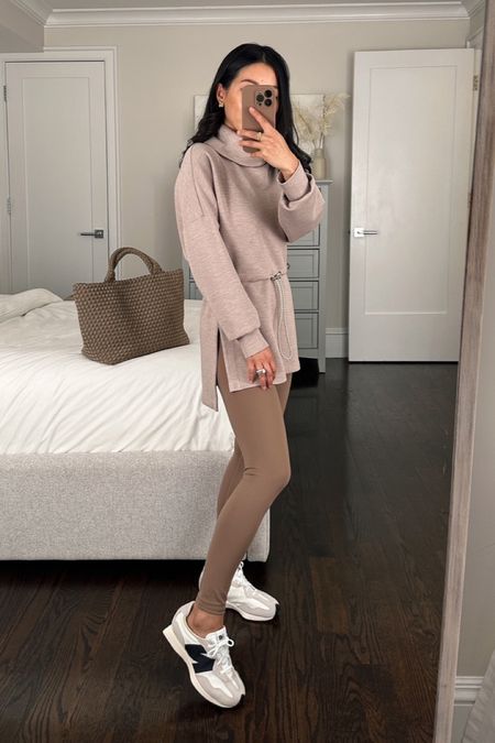 Spring athleisure outfit with a tunic top to throw over leggings 

Varley double soft fabric feels so luxe for loungewear- lives up to their rave reviews! I used  code VARLEY10 for 10% off  

• Sweatshirt tunic in Taupe xxs - oversized relaxed fit with longer back length for wearing with leggings. Drawstring waist. the sleeve length is also a little long on me (pushed up in this pic). 

I ordered several Varley doublesoft pieces to try and also kept the Davidson half zip linked in xxs - it’s a shorter length than their other pullovers and a nice relaxed fit for petites! 

• Varley High Rise Legging 25 in Taupe Stone xs - the xs is long on me - hems are folded under. 

The xxs is too skin tight on me so I sized up to Xs. I've also linked a similar neutral legging from Lululemon that comes in a more petite friendly 23 or 25" inseam. The lulu has more of a lighter and cooler tone color 

 • sneakers are New Balance 327s size kids 4 which fits like a women’s 6. 

I can also wear their women’s 5.5 in this sneaker style. Super lightweight! 

• Naghedi St. Barth's tote in medium cashmere 

#petite friendly casual athleisure 

#LTKfitness #LTKSeasonal #LTKActive