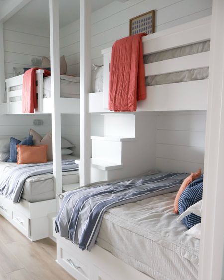 Beach House bunk room with accents of navy and orange for beachy, surf playful vibe 

#LTKkids #LTKfamily #LTKhome
