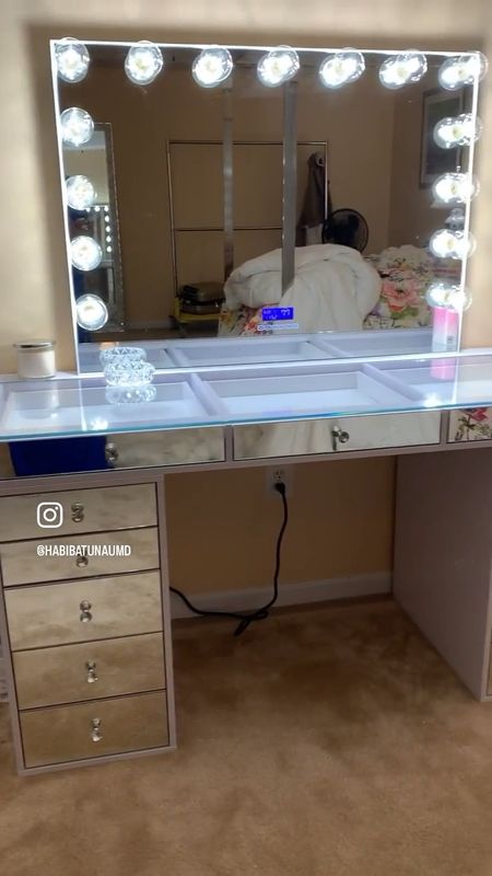 My dream vanity from Impressions Vanity. Beautiful, Elegant and oh so functional! It makes me so happy and the lights are amazing! I store not only my makeup 💄 here but also some of my fancy jewelry. I love the mirror covered draws and all the compartments. 
I also have the glam mirror which has Bluetooth and can connect to my favorite music! 
Ps I have the largest  Slaystation in white purchased  a few years ago from Impressions Vanity Mirrored.  You can buy it without the mirrored draws for a much lower price and it comes in smaller sizes to fit your space and you can buy the parts in a bundle or just the display desk or just the Hollywood mirror. 
If you don’t need a glam station consider a table top lighted small mirror for when you need a closer look doing your makeup. 
Girl I could go on! If you want a glam area this is it! You deserve it! 

#LTKhome #LTKstyletip #LTKbeauty
