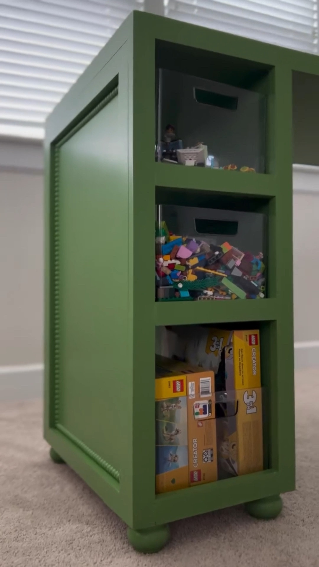 My girls are huge Lego fans and I was so tired of their builds being spread out all over the floor. But every Lego table I found online was designed for toddlers… nothing that actually worked for older kids who want room to create. So I finally did something I’ve never done before… I built them a table.

There were definitely challenges. It is not perfect. And I learned a whole lot along the way. But this Lego table turned out absolutely perfect for them. I added storage shelves sized exactly for our clear bins, neutral Lego mats, open build zones, beadboard paneling, chunky little legs, and a pretty coat of green paint to make it feel like part of our home instead of a toy.

Seeing the girls already creating on it makes every second worth it. And yes, the wallpaper is next. Stay following because this playroom is about to look so cute.

#LegoTableDIY #PlayroomDIY #KidsRoomMakeover #DIYFurniture #DIYMoms #HomeDIYProjects #PlayroomStorage #KidsRoomInspo #DIYKidsFurniture