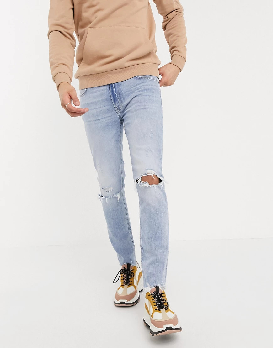 Bershka skinny jeans with knee rips in light blue wash | ASOS (Global)