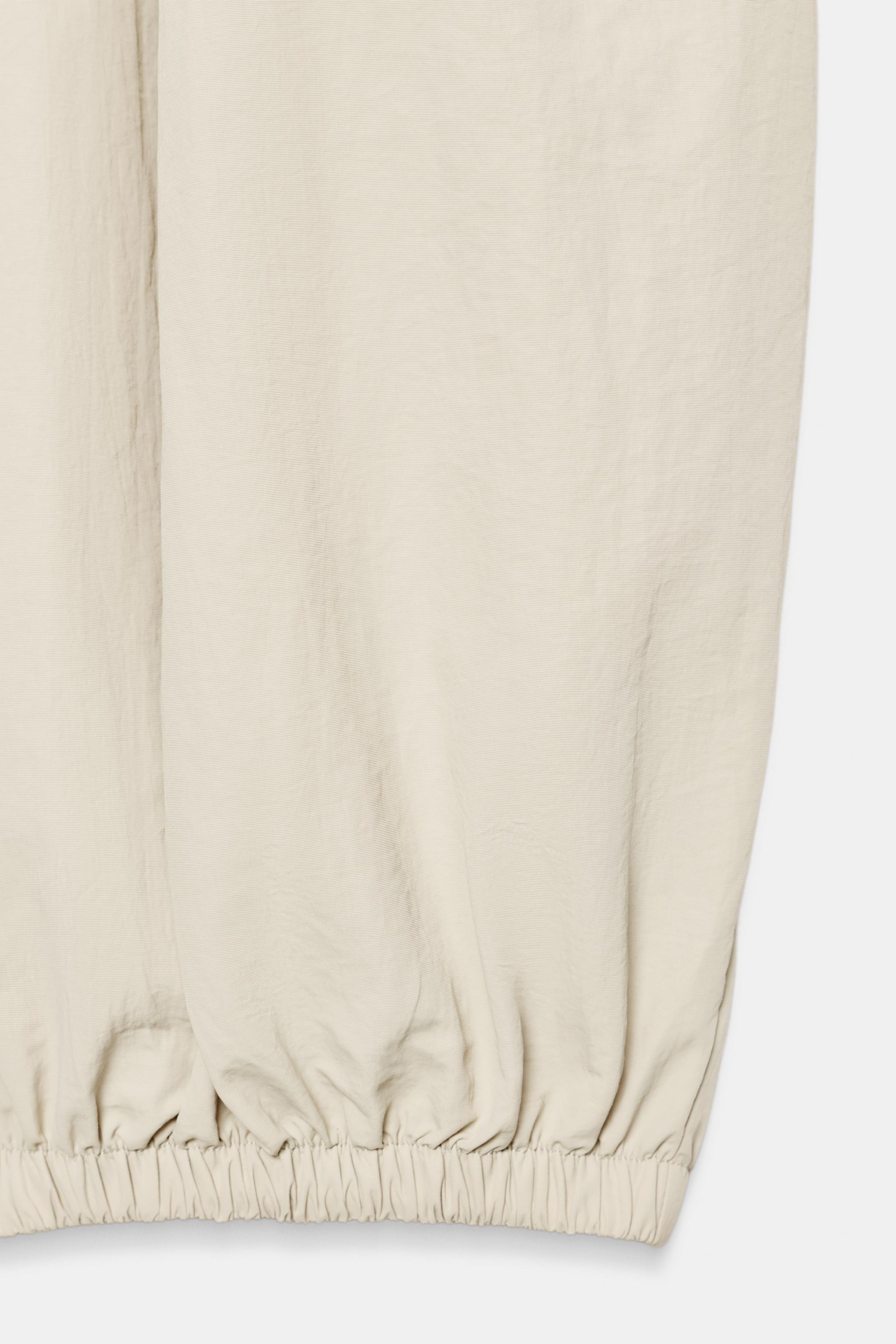 Trousers crafted from 100% polyamide. Features a mid-waist with an elasticated waistband, side po... | Zara UK