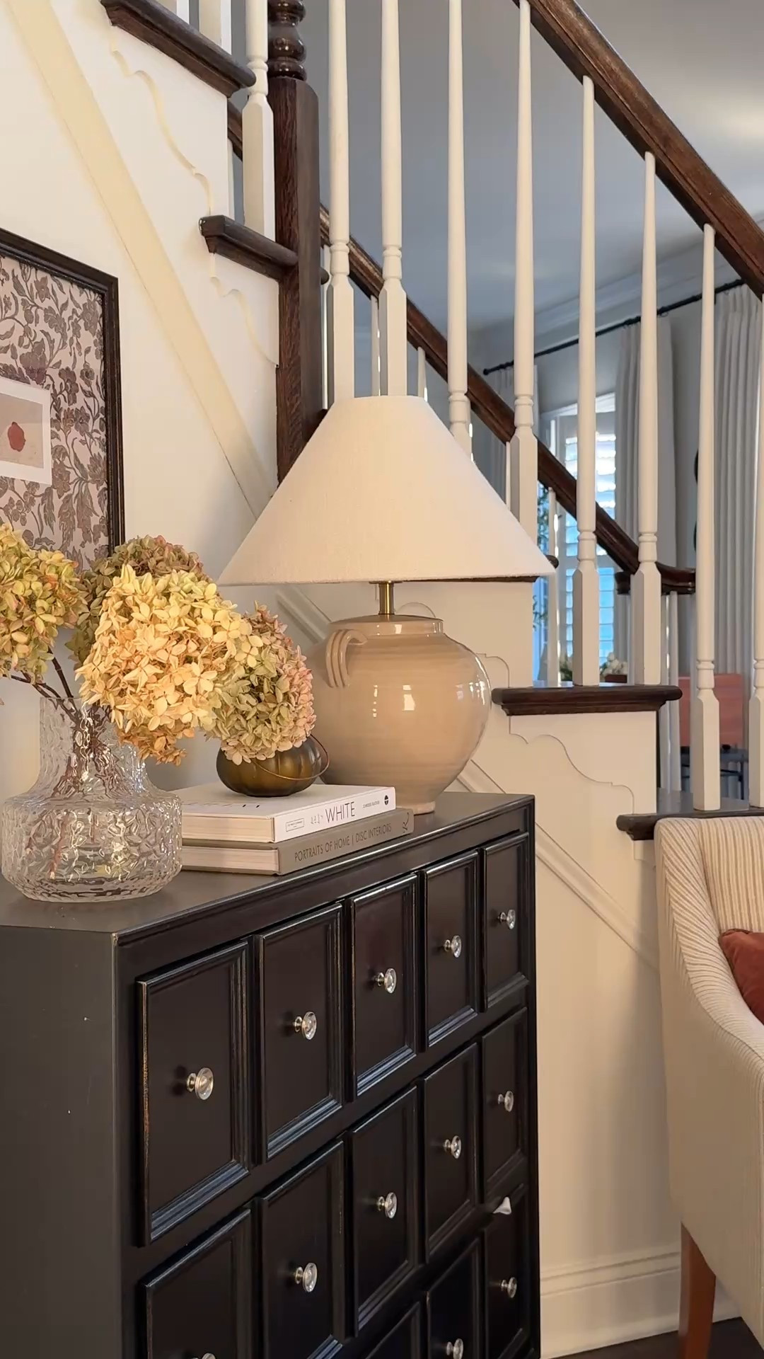 Create a magical fall foyer with dried hydrangeas, moody framed wall art, velvet deep orange pillow, striped chair, fall candles, a few books and an empire shade lamp. 

Fall decor
Foyer decor
Ceramic table lamp
Dried hydrangeas
Fake flowers
Faux stems
Fall throw pillows 


#LTKHome #LTKHalloween #LTKSeasonal