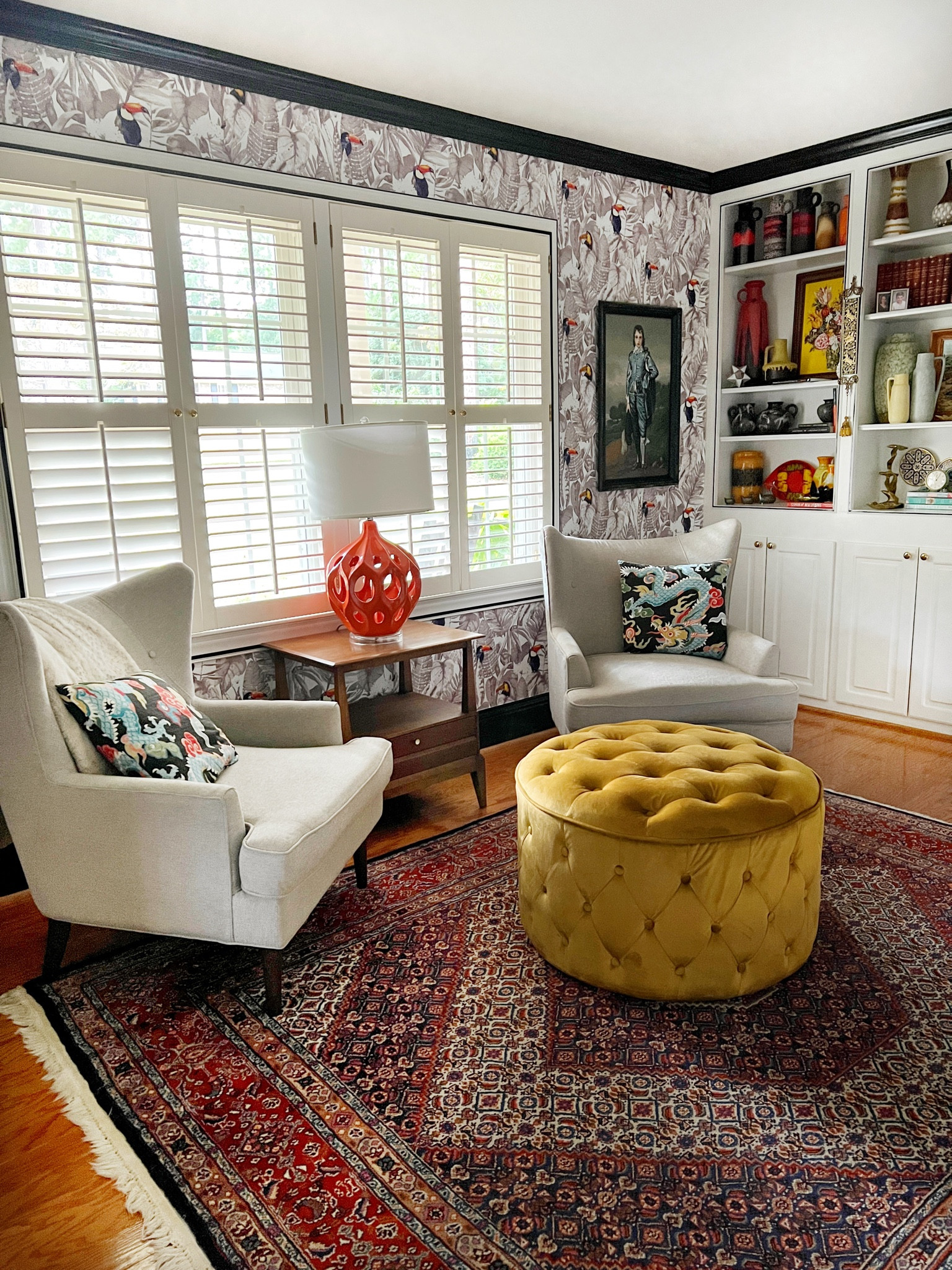 Living room, vintage home, mid century, colorful home, round ottoman, orange lamp, wing chair, vintage rug, Persian rug, dragon pillows, removable wallpaper, black and white

#LTKhome