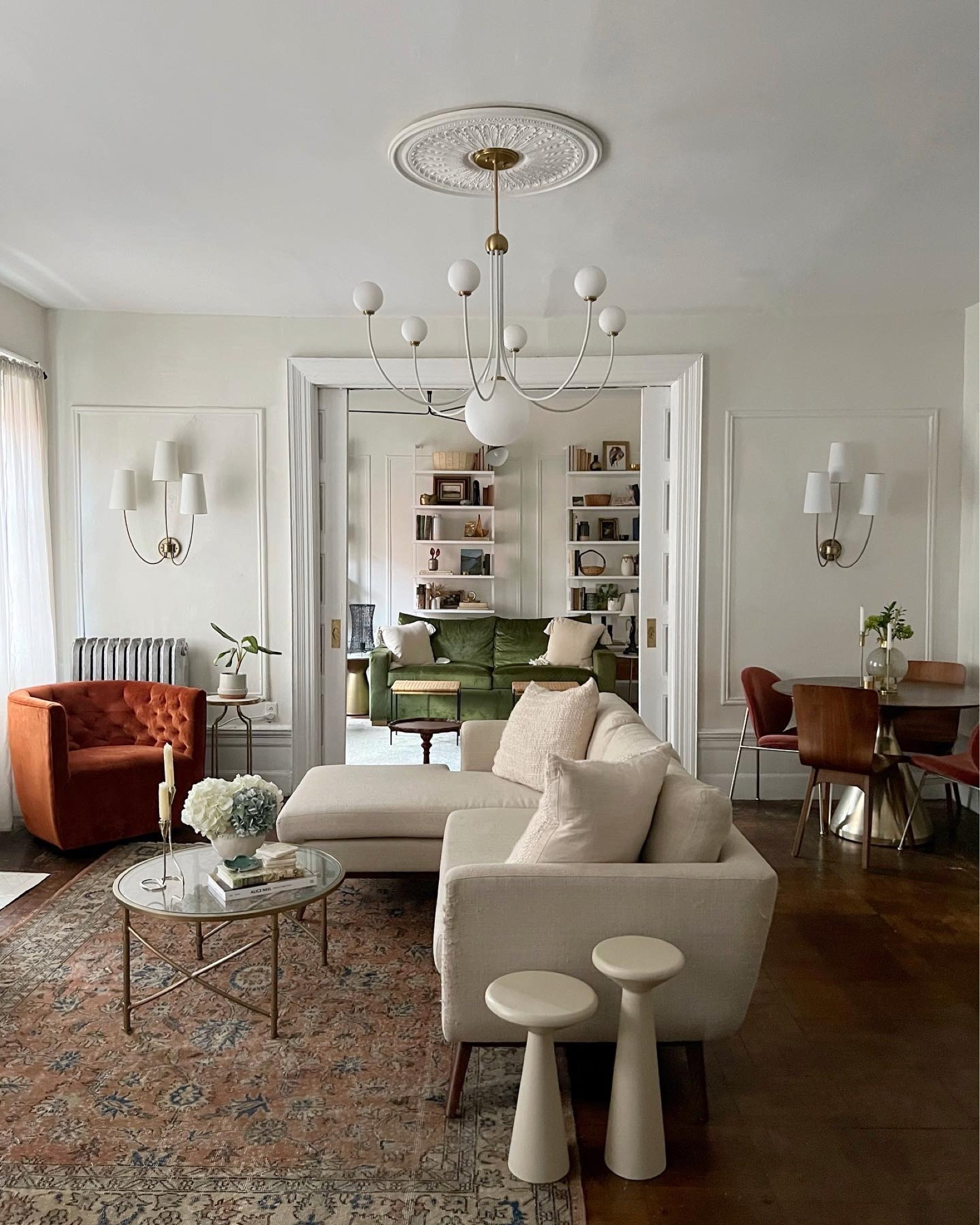 Living room furniture, decor, off white sectional sofa, rust cognac velvet swivel chair, white accent tables set of two, wall sconces, round glass coffee table, vintage rug 

#LTKstyletip #LTKhome