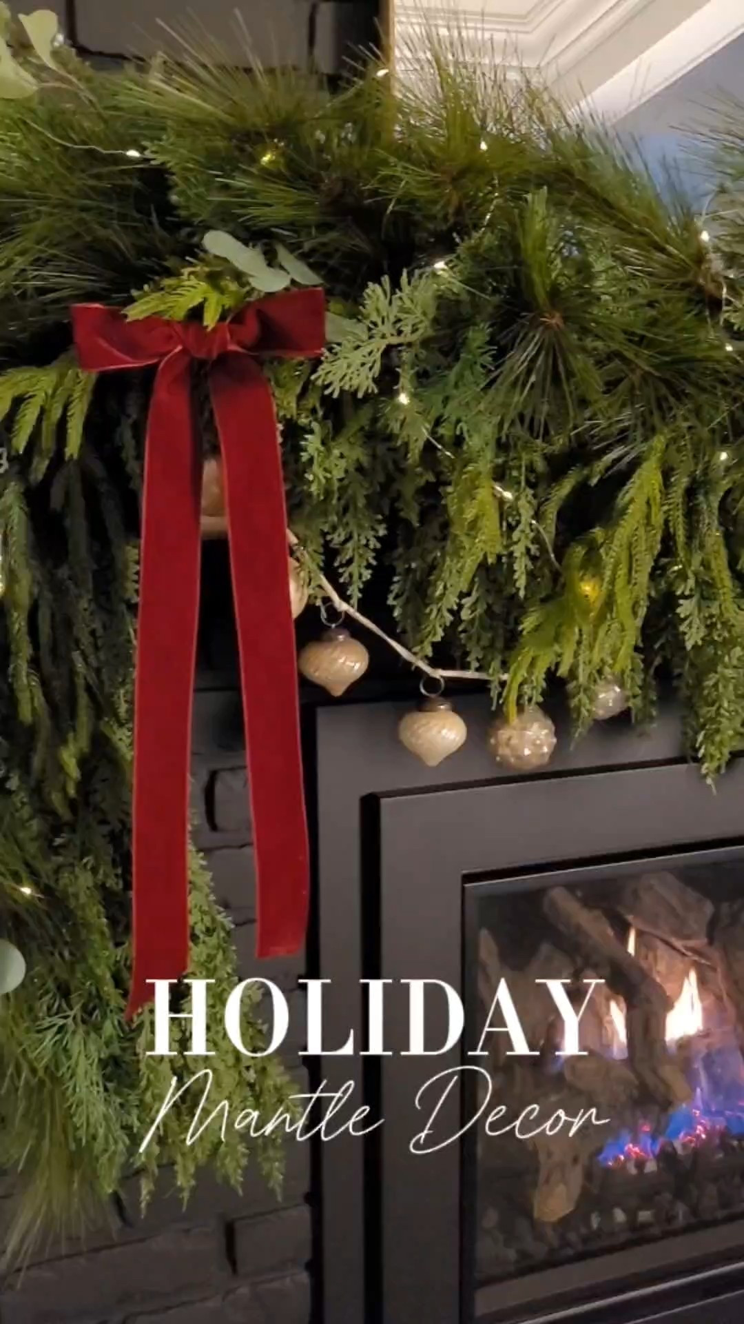 Holiday mantle decor with layered garland, ornaments, dark burgundy velvet ribbon for a Ralph Lauren Christmas. Christmas decor, Christmas mantle, living room, family room, arch mirror, mantle mirror

#LTKHome #LTKHoliday