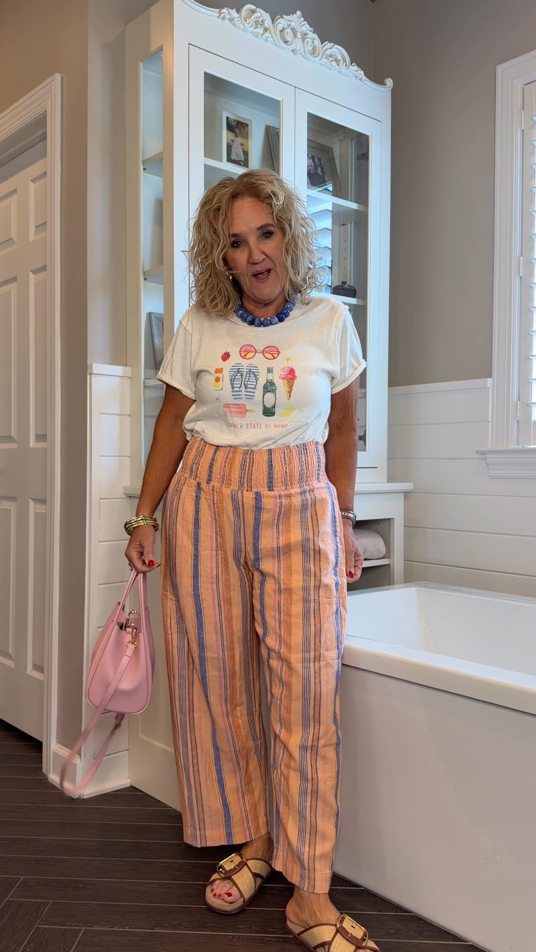 These Reese striped pants are incredibly comfortable with a smocked waistband that you can wear higher or lower depending on your preference. I paired them with a cute graphic tee and blush accessories for an easy, colorful summer outfit.

✨Get 20% off orders of $100+ with code NANETTE20.

Sizing:
• Reese Pants – Small (I sized down.)
• Graphic Tee – Medium

Jeans, tops, dresses, shoes, jewelry, and so many cute finds are included in the sale!

💡 LTK MADE EASY
❤️ Heart = Support my posts!
🔖 Save = Get sale & restock alerts
📋 Lists = Keep favorites organized
📲 Share = Send lists and products to a friend. Hello, Christmas List!
💬 Comment = Ask me anything about sizing or fit. :-)

#LTKootd #LTKSeasonal #LTKOver40