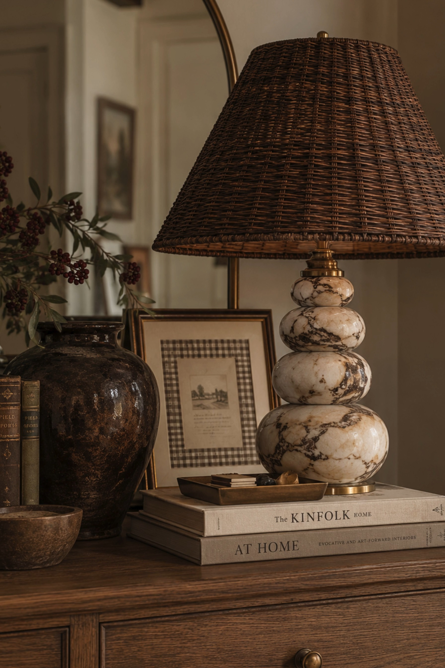 Collected Console Styling 🤎 This warm, layered vignette blends English country decor, modern traditional style, and vintage-inspired home accents for a timeless collected look. A statement marble table lamp with a woven rattan shade sits atop neutral coffee table books, while antique-style books, a dark ceramic vase, framed artwork, brass accents, and seasonal berry branches add rich texture and old-world character. Warm wood tones, natural woven materials, marble details, and earthy brown hues make this console table styling perfect for cozy fall interiors and sophisticated neutral homes.

🖤 If you want to see more content like this, FOLLOW maeveandmodern on LTK, Instagram, and Pinterest! Check out our blog where we post daily, maeveandmodern.com!

Console Table Styling | Console Decor Ideas | Entryway Decor | English Country Decor | Modern Traditional Decor | Collected Home Style | Vintage Inspired Decor | Marble Table Lamp | Woven Lamp Shade | Rattan Lamp Shade | Statement Table Lamp | Designer Lighting | Neutral Home Decor | Brown Home Decor | Warm Wood Furniture | Coffee Table Books | Decorative Books | Vintage Books | Ceramic Vase | Framed Vintage Art | Brass Home Accents | Fall Branches | Fall Home Decor | Cozy Fall Decorating | Earthy Home Decor | Organic Modern Decor | Transitional Interiors | Old World Decor | Luxury Home Styling | Cozy Home Inspiration

#LTKHome #LTKSaleAlert #LTKSeasonal