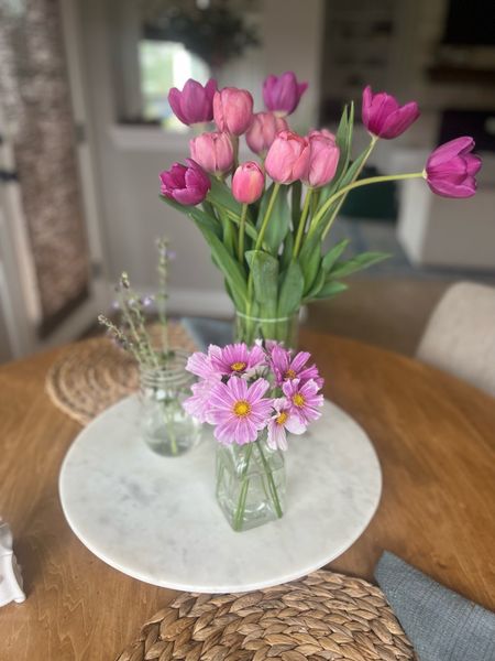 Spring kitchen table decor with spring blooms, tulip arrangement and bud vases of cosmos flowers and sage buds on my favorite white marble lazy Susan & Woven hyacinth placemats.

Spring table decor, breakfast nook, table setting, spring kitchen style, spring tablescape, Easter, Mother’s Day, floral arrangements, clear Bud vases, Juliska dishes

#LTKSeasonal #LTKhome #LTKunder50