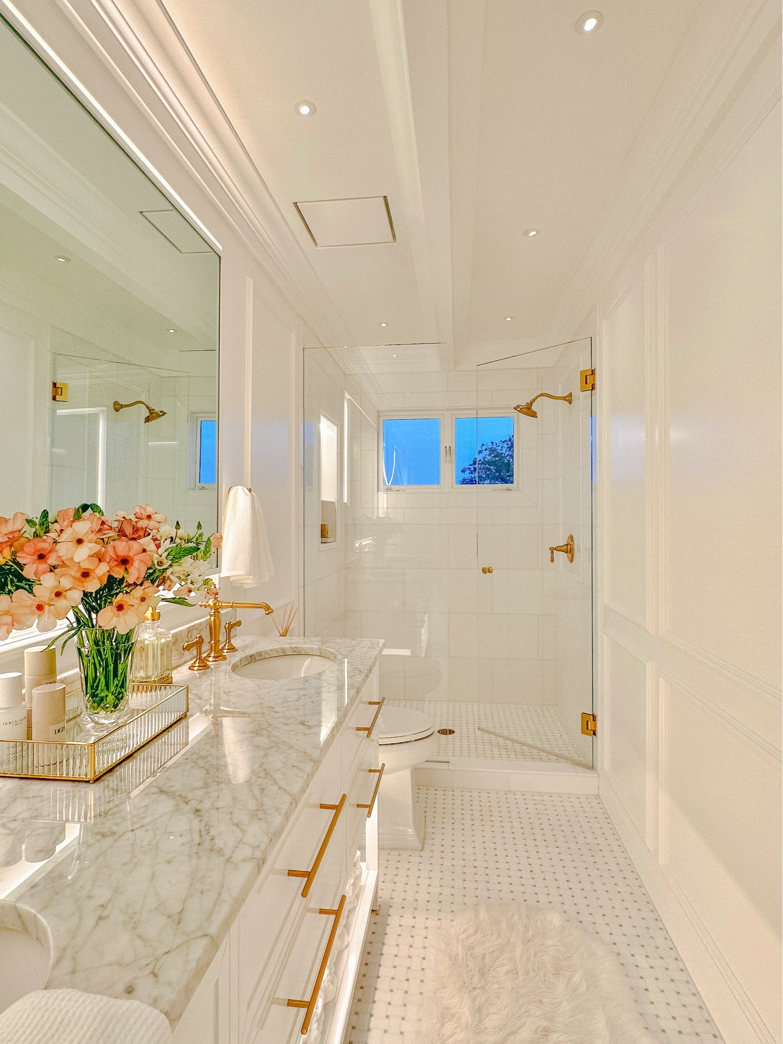 Primary bath details 🚿
Tile is from AKDO - Thassos & Azul marble in basketweave on floor, Thassos polished 12x24” tiles in shower and 3/8” x 3/8” Thassos marble interlocking tiles in shower niche. 

Paint - Benjamin Moore Advance Paint - Chantilly Lace in Satin finish. 

Flush ceiling vent - Fittes Exhaust Mount Luxe

Vanity has a Carrera countertop and 8” faucet holes  


#LTKHome