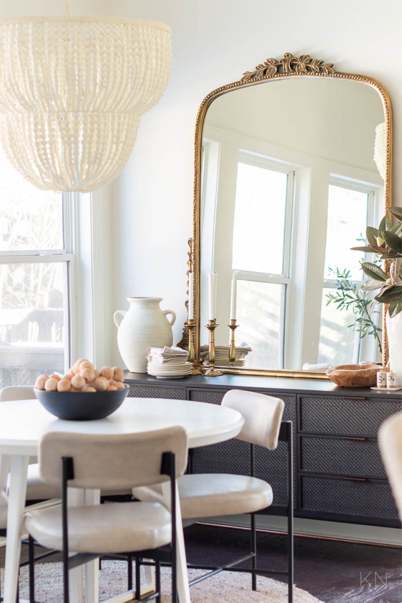 Our breakfast nook is one of the most used spaces in our home since we eat most of our meals there. The black cane sideboard is great for storage and the large gold Primrose mirror opens up the space. home decor dining room decor round white dining table leather dining chairs white bead chandelier round jute rug faux magnolia stem large white ceramic vase

#LTKStyleTip 

#LTKHome