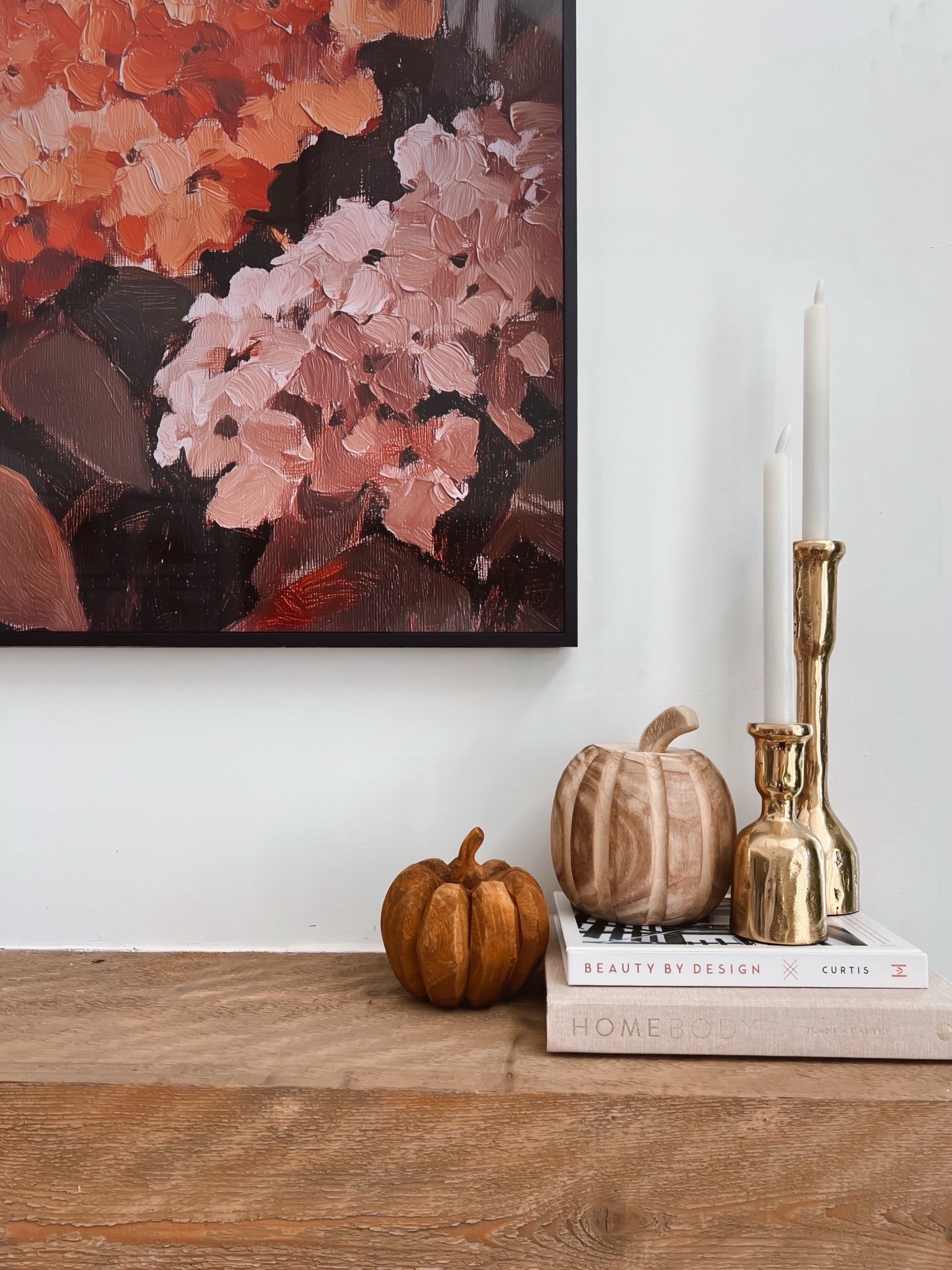 Fall mantle decor with wood carved pumpkins, gold candle holders and coffee table books. Also linking our new fall Samsung frame TV art that comes in a bundle of 120! 

#LTKStyleTip #LTKHome