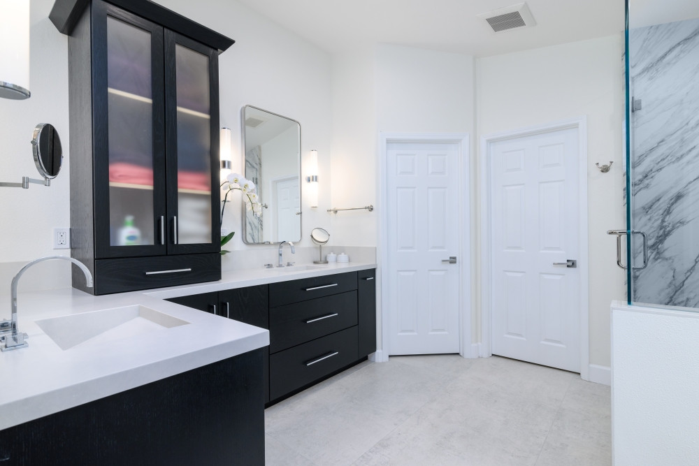 Bold and balanced—this primary bathroom remodel is all about modern contrast and smart storage. We designed and remodeled the space with rich painted oak cabinetry, sleek chrome fixtures, and clean quartz countertops for a refined, high-contrast look. The frosted glass tower adds vertical storage while keeping essentials within reach but with added privacy. It's a space that feels luxurious yet livable, with every detail intentionally crafted.

Let us help you turn your bathroom into a beautifully functional retreat.

#BathroomRemodel #PrimaryBathInspo #CustomVanity #QuartzCountertops #ModernBathroomDesign #FrostedGlassCabinet #BlackAndWhiteDesign #LTKHome #PinterestBathroom #DesignBuildFirm #InteriorDesignInspo #LuxuryBathroom #SpaInspiredBath #StorageGoals #RemodelReveal #BoldBathroomStyle 

 #LTKHome