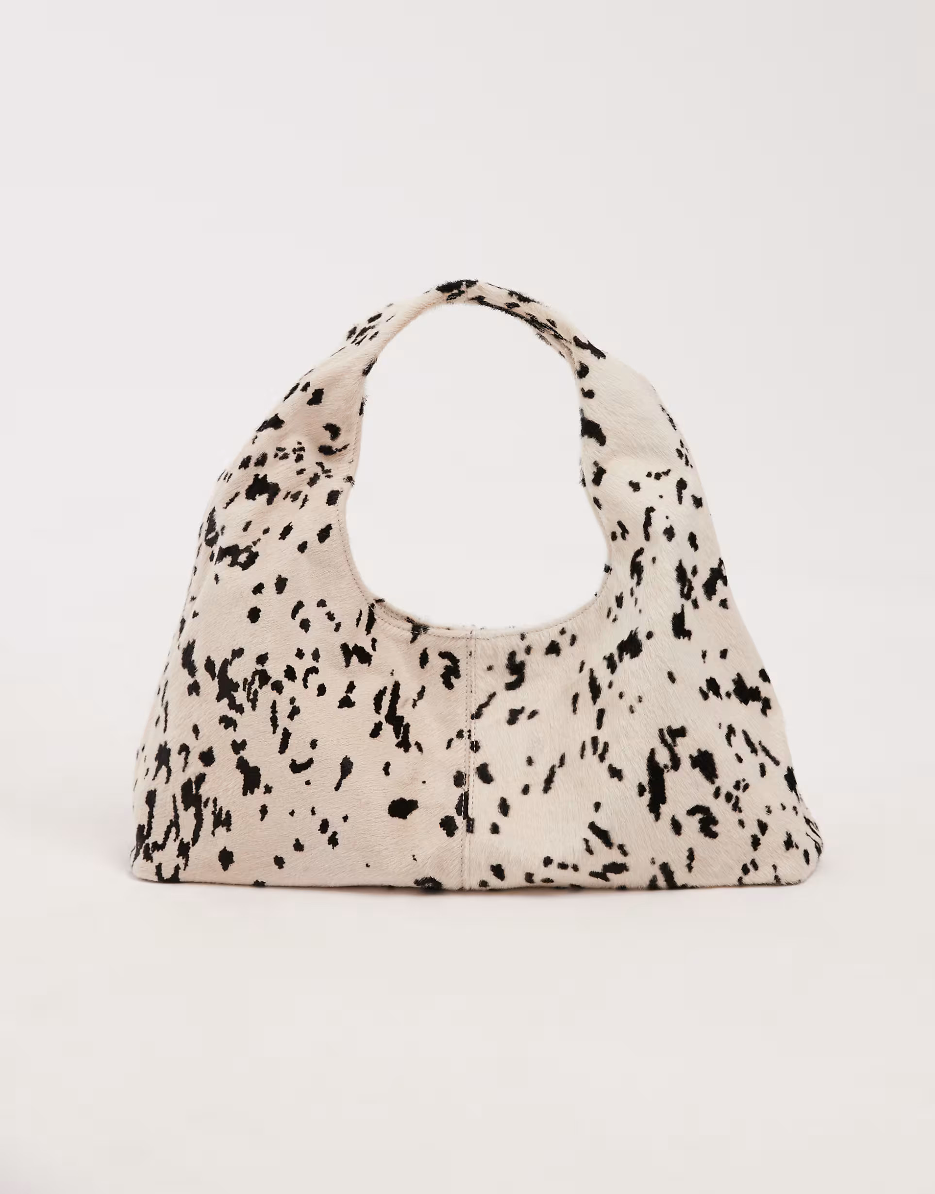 ASOS DESIGN pony hair mid size slouch shoulder bag in cow print | ASOS (Global)