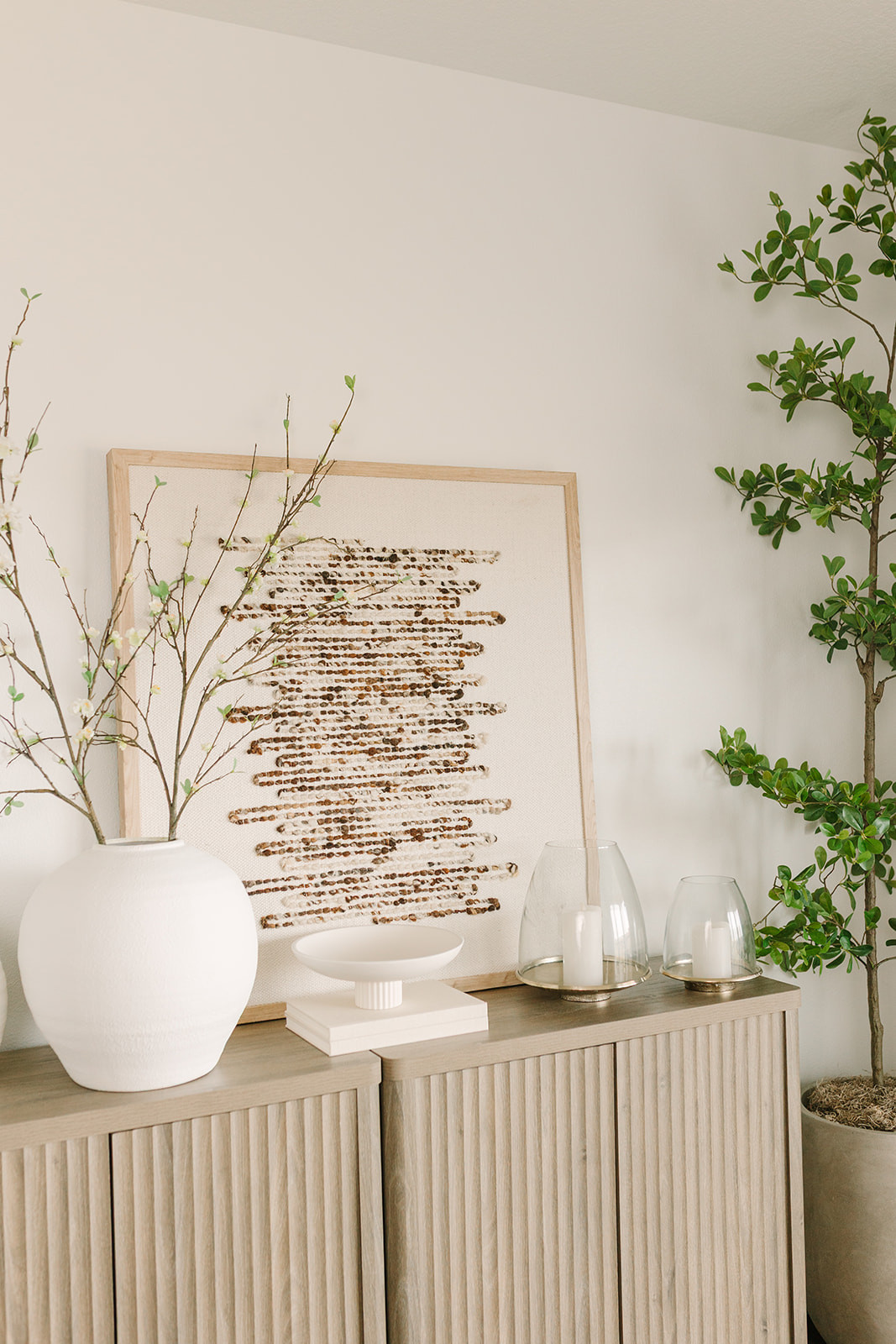 You guys are loving this white vase and stems 🤍 Such a simple combo that instantly brightens a space, especially styled with my favorite cabinets, a gorgeous faux olive tree, stunning candles, and a trending art piece. 

 

#LTKHome