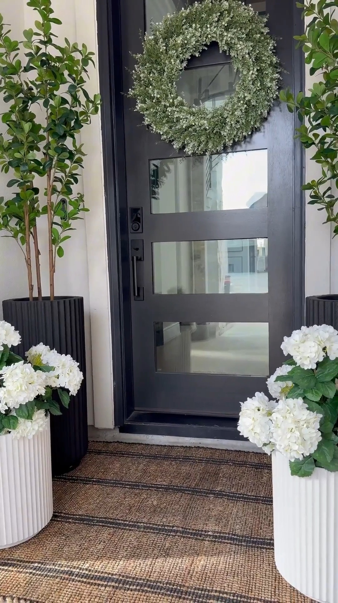 The fluted planters completely stole my heart.....the tall black ones add such great contrast, the shorter white ones soften everything perfectly. 🥰

You know I love a classic black + white foundation 😆 ....and this rug? It adds just the right amount of warmth. It worked beautifully through fall and winter, and I already know it’ll carry us right into summer too.

I layered in fresh hydrangeas (because honestly, I can never have too many) 😜 plus some leafy green trees to bring that bright, lively summer feel to the space.

And this oversized wreath... such a stunning statement piece. This space feels so light, fresh, and welcoming for the sunny days ahead! ☀️☺️

Create your own dreamy summer space! Click the link to shop everything!

#LTKHome #LTKSaleAlert #LTKSummerSale #SummerHome #PatioStyle